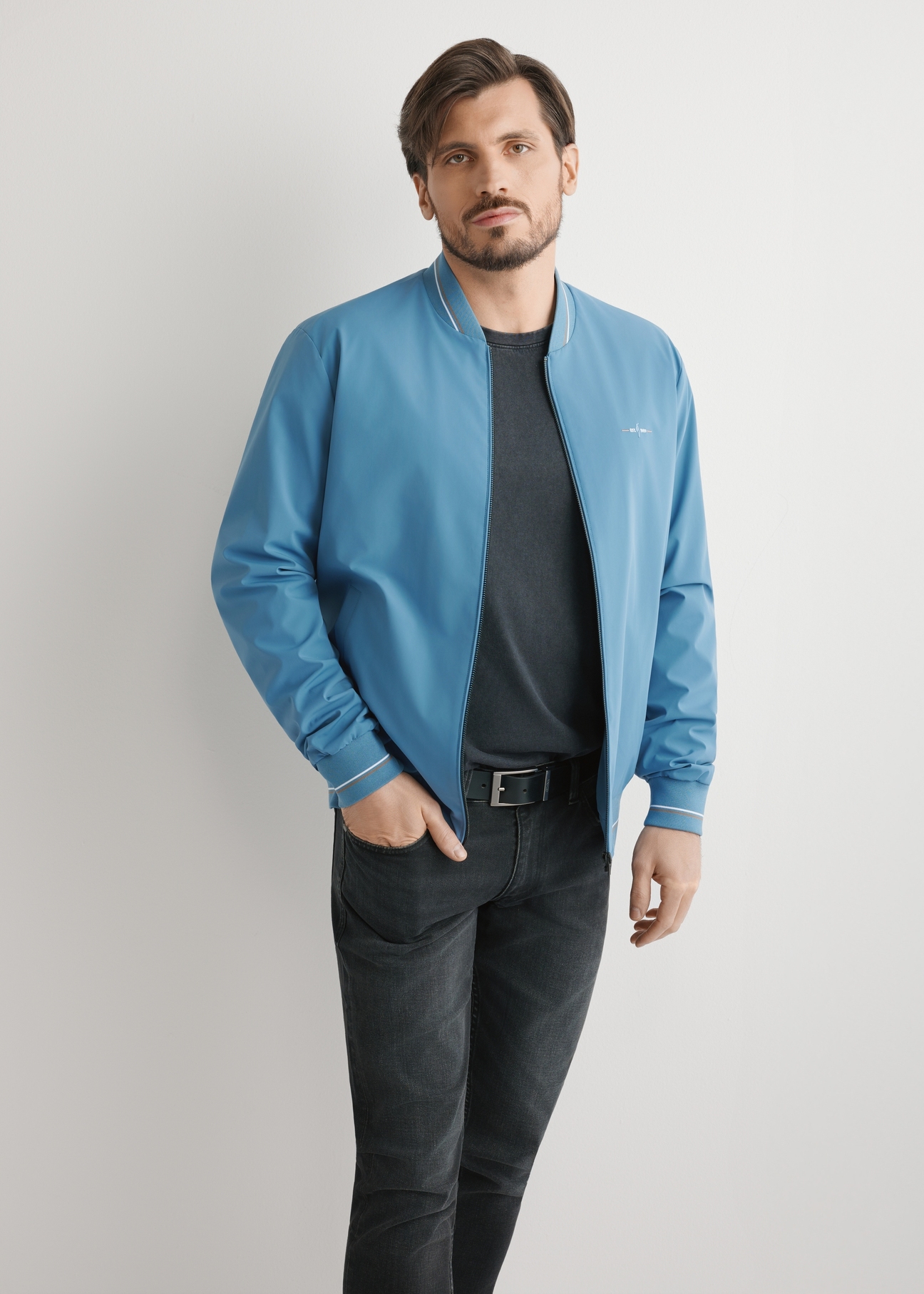 Men's blue nylon jacket KURMT-0416-7C(W26), front product view on model. Half silhouette visible.