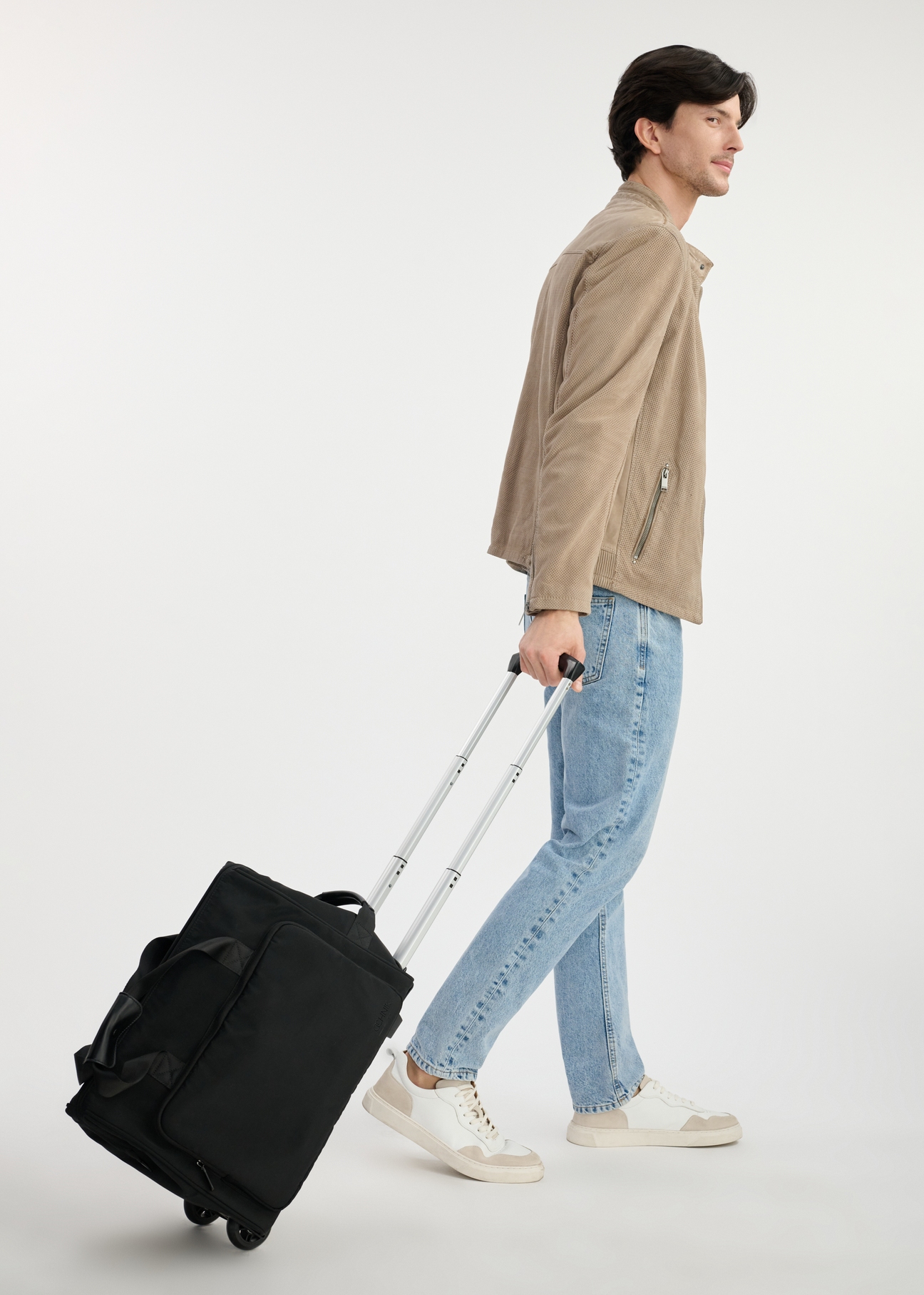 Black travel bag on wheels TORMN-0347-99(W25), product view from the side. The entire silhouette of the model is visible.