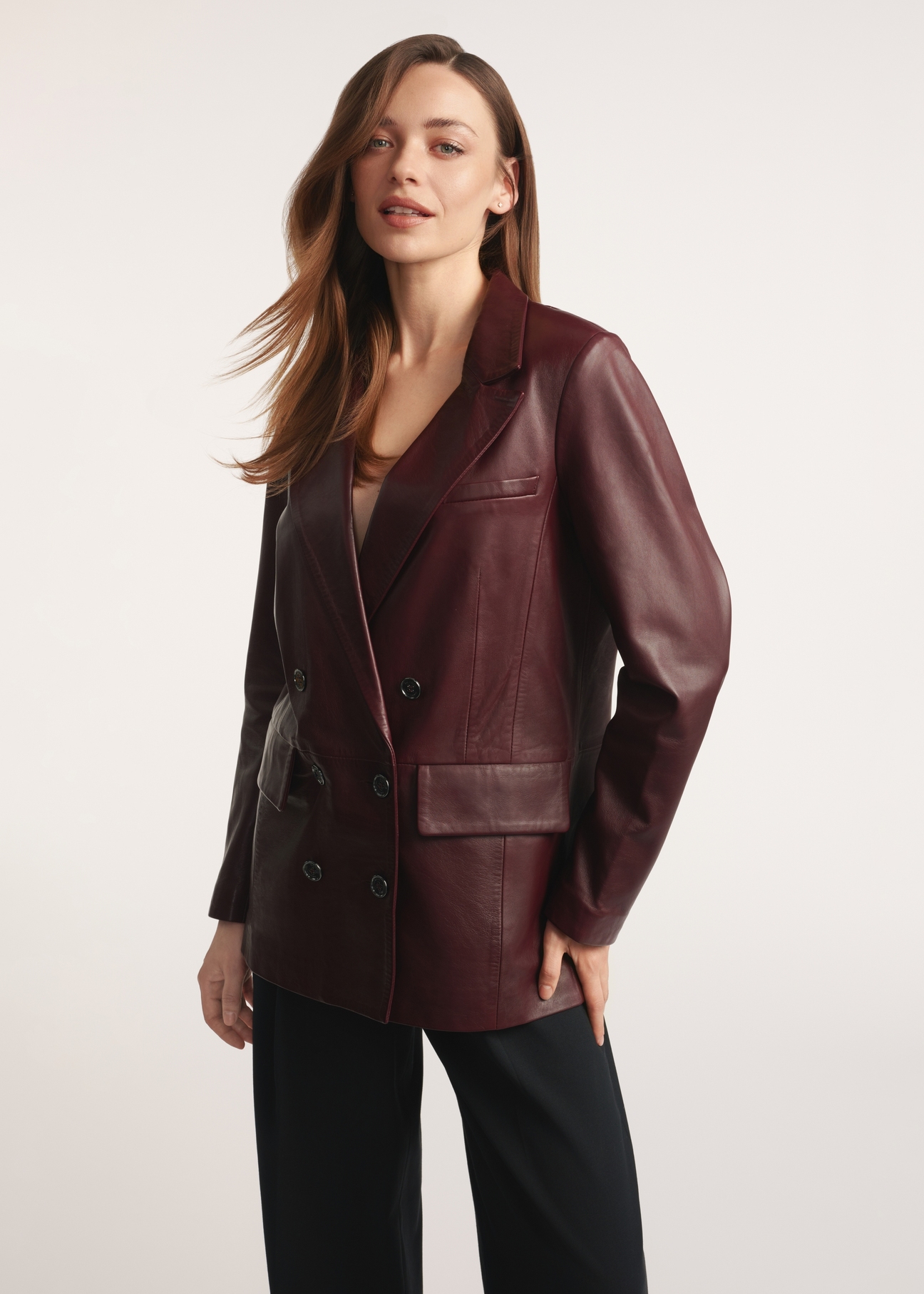 Burgundy women's leather jacket KURDS-0556-2869(Z25), front view of the product on the model, half of the silhouette visible.