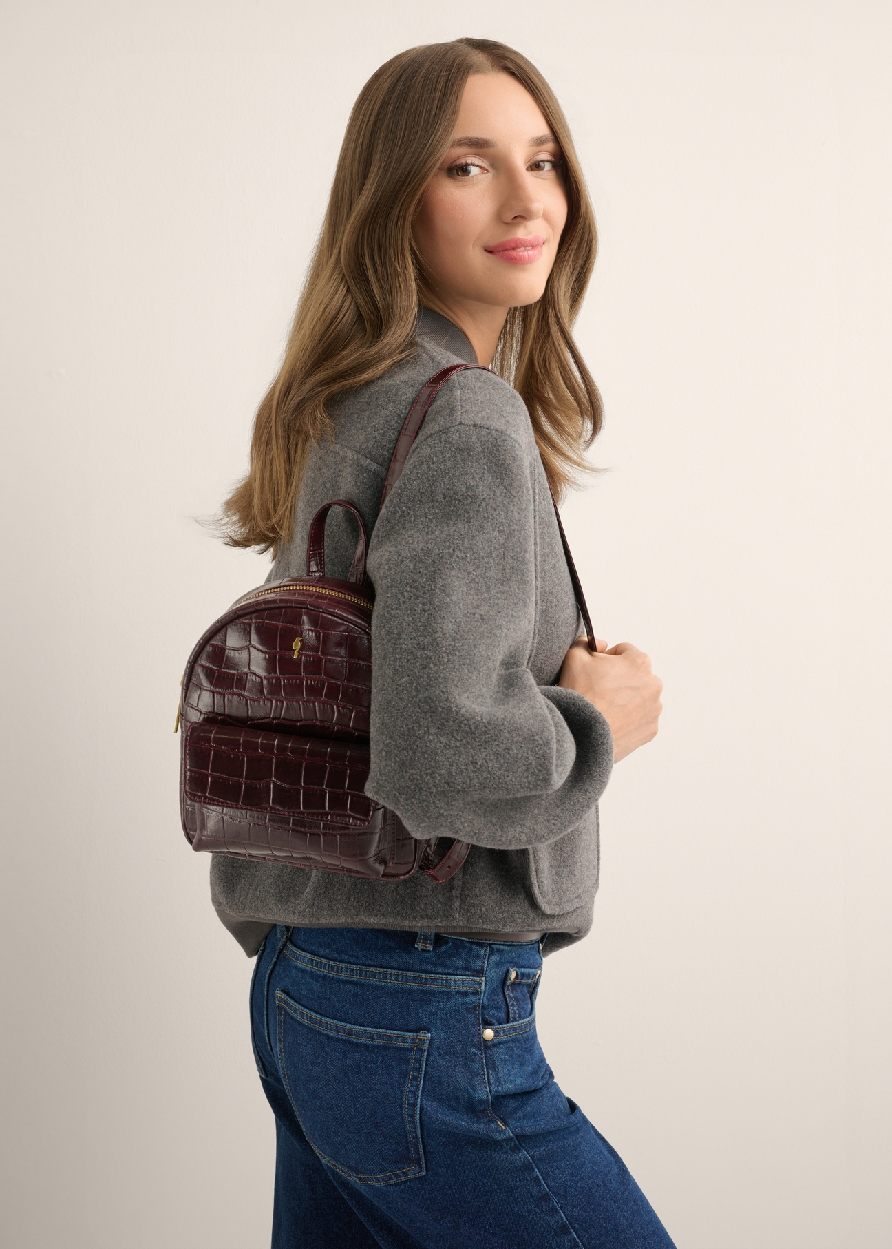 Burgundy croco women's leather backpack TORES-1323-4D(Z26), front view of the product on a model. Half of the silhouette visible.