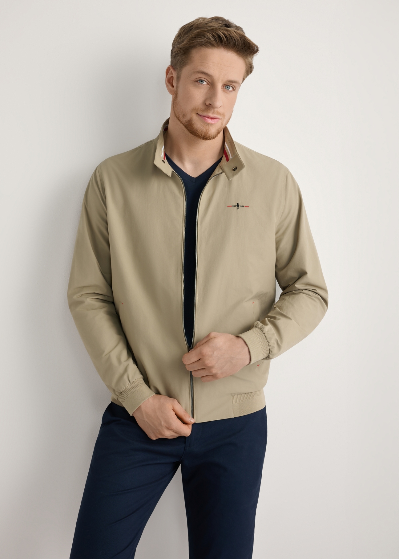 Beige men's lightweight transitional jacket KURMT-0370-1B(W26) - front product view, modeled, against a light background. Knee-length silhouette visible.
