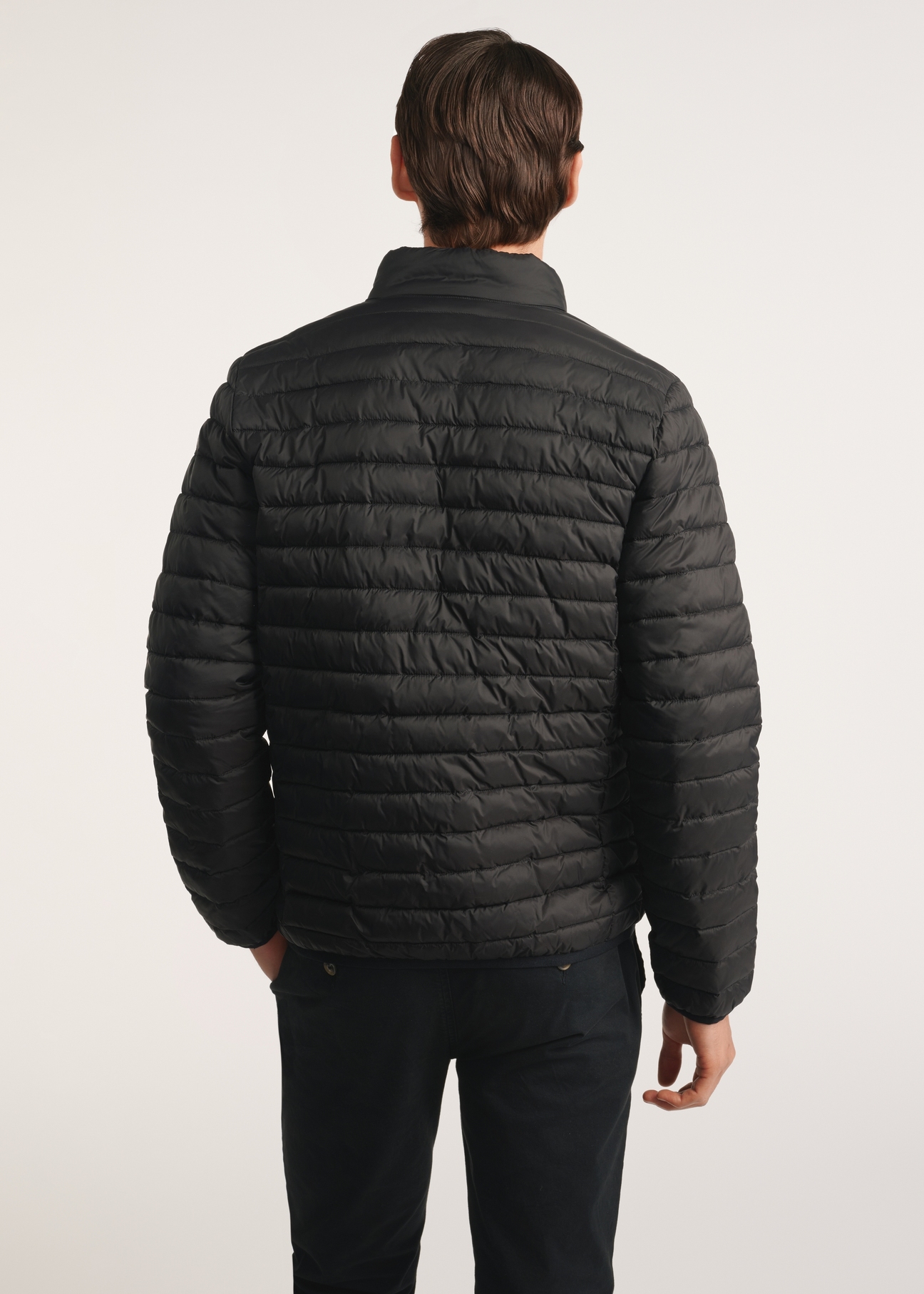 Black men's transitional jacket KURMT-0382-99(Z25), product visible from the back on the model, half of the silhouette visible.