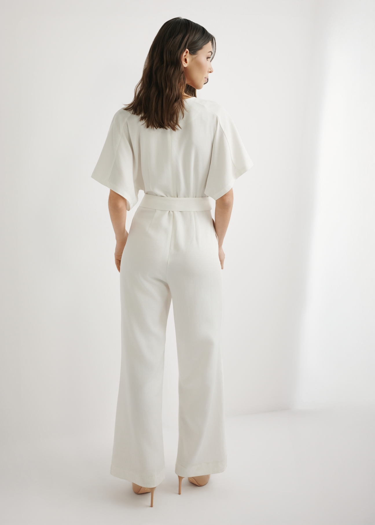 Women's cream jumpsuit KOBDT-0013-0B(W26), back view of the product on the model. Full body visible.