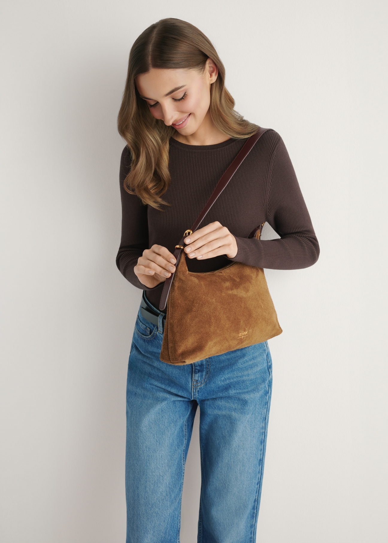 Women's suede handbag in camel color TORES-1303-1D(W26), product view on model's shoulder, against a light background.