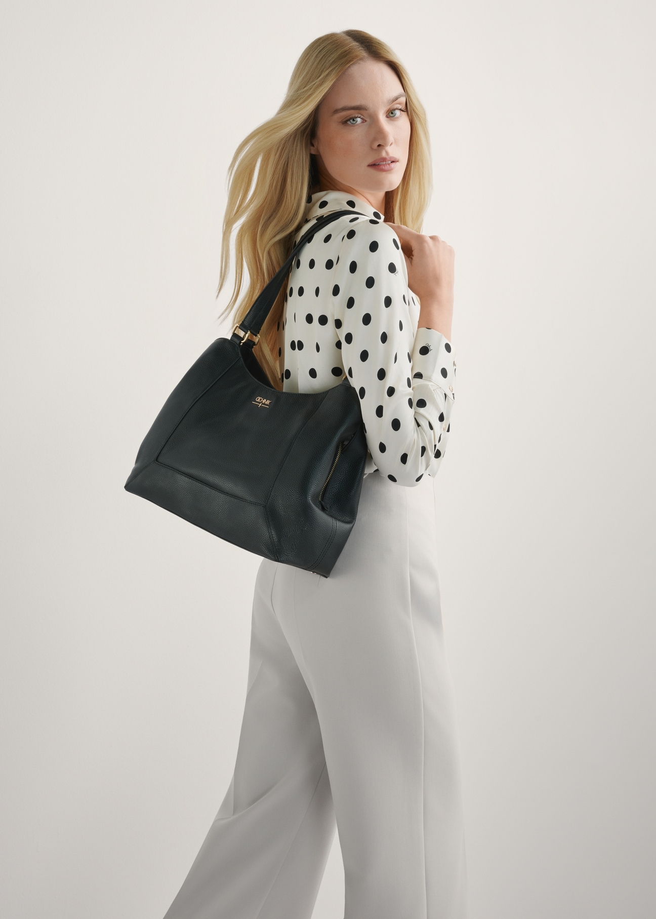 Women's black leather shopper bag TORES-1264-9I(W26), product view on model's shoulder. Half of silhouette visible.