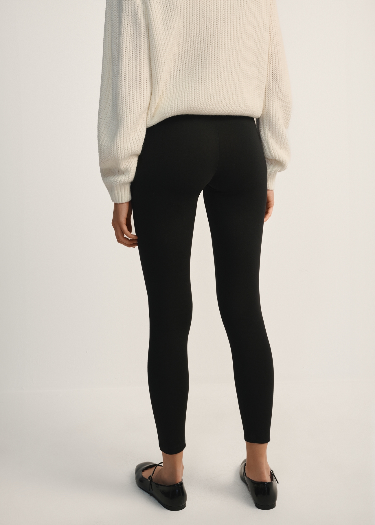 Black women's leggings LEGDT-0001-99(Z25), product view from the back on the model, half of the silhouette visible.