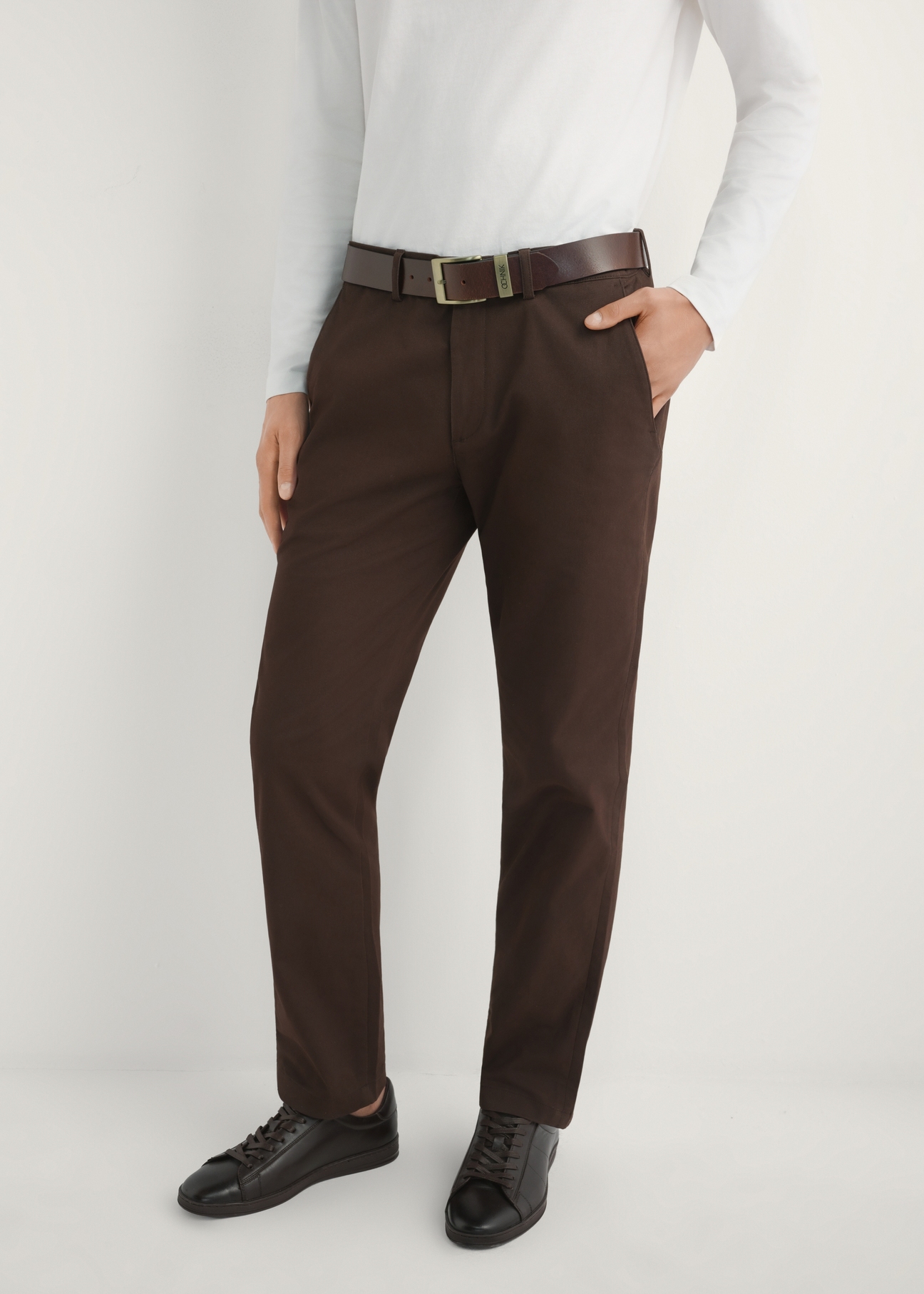 Men's brown trousers SPOMT-0121-1I(W26) - front view of the product, on a model, against a light background. Half of the silhouette visible.