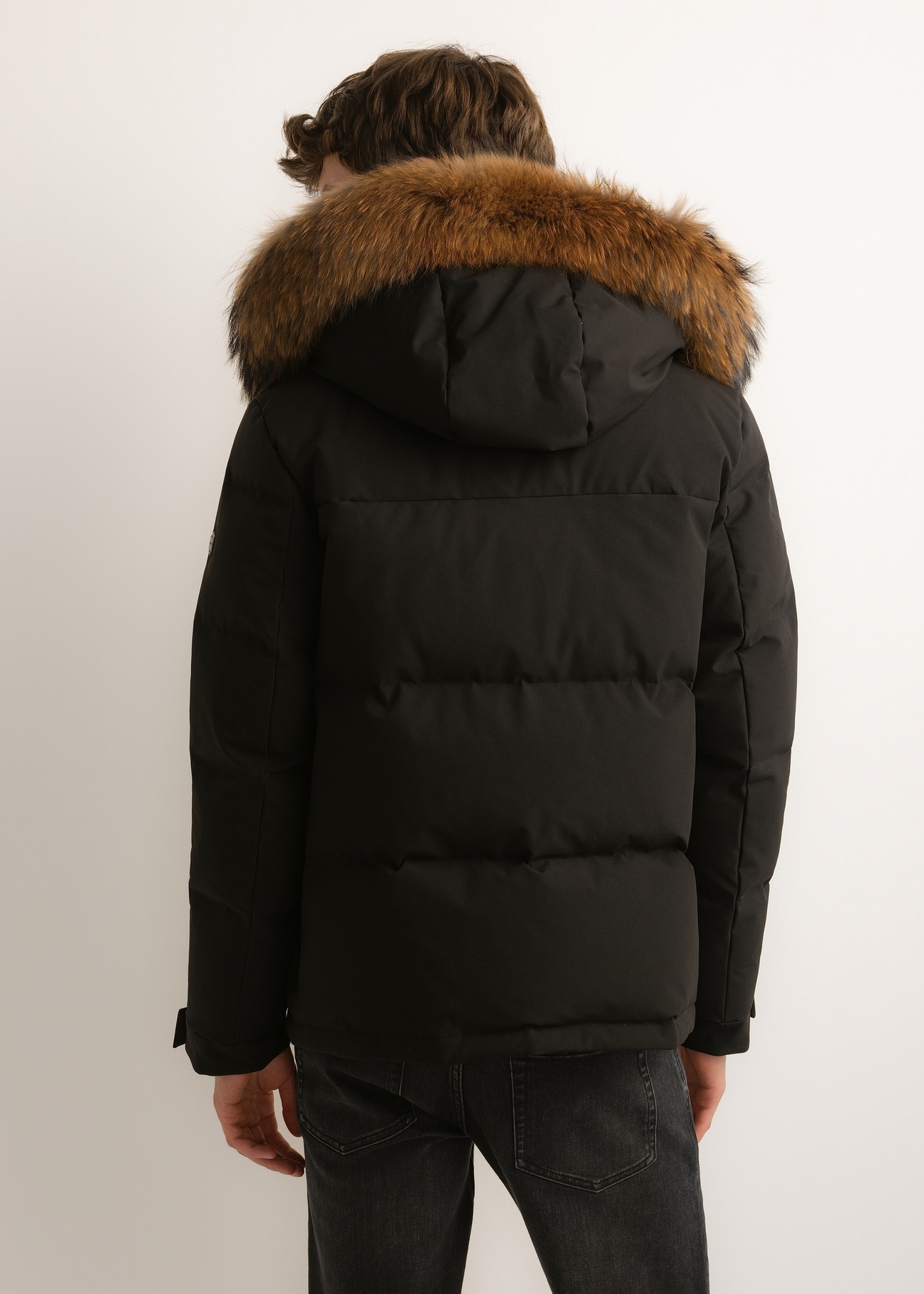 Men's black winter jacket KURMT-0434-99(Z26), rear view on a model. Half of the figure is visible.