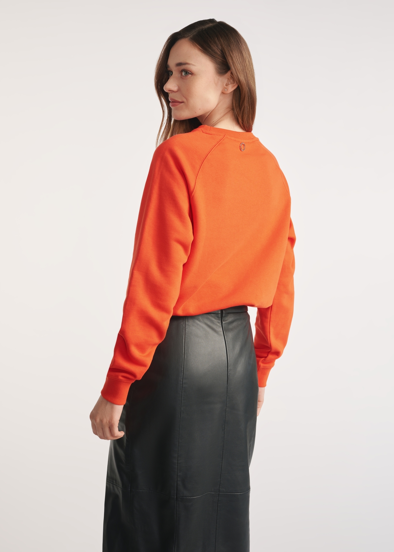 Orange women's sweatshirt BLZDT-0114-30(Z25) - product view from the back on a model on a white background. Visible silhouette to the knees.