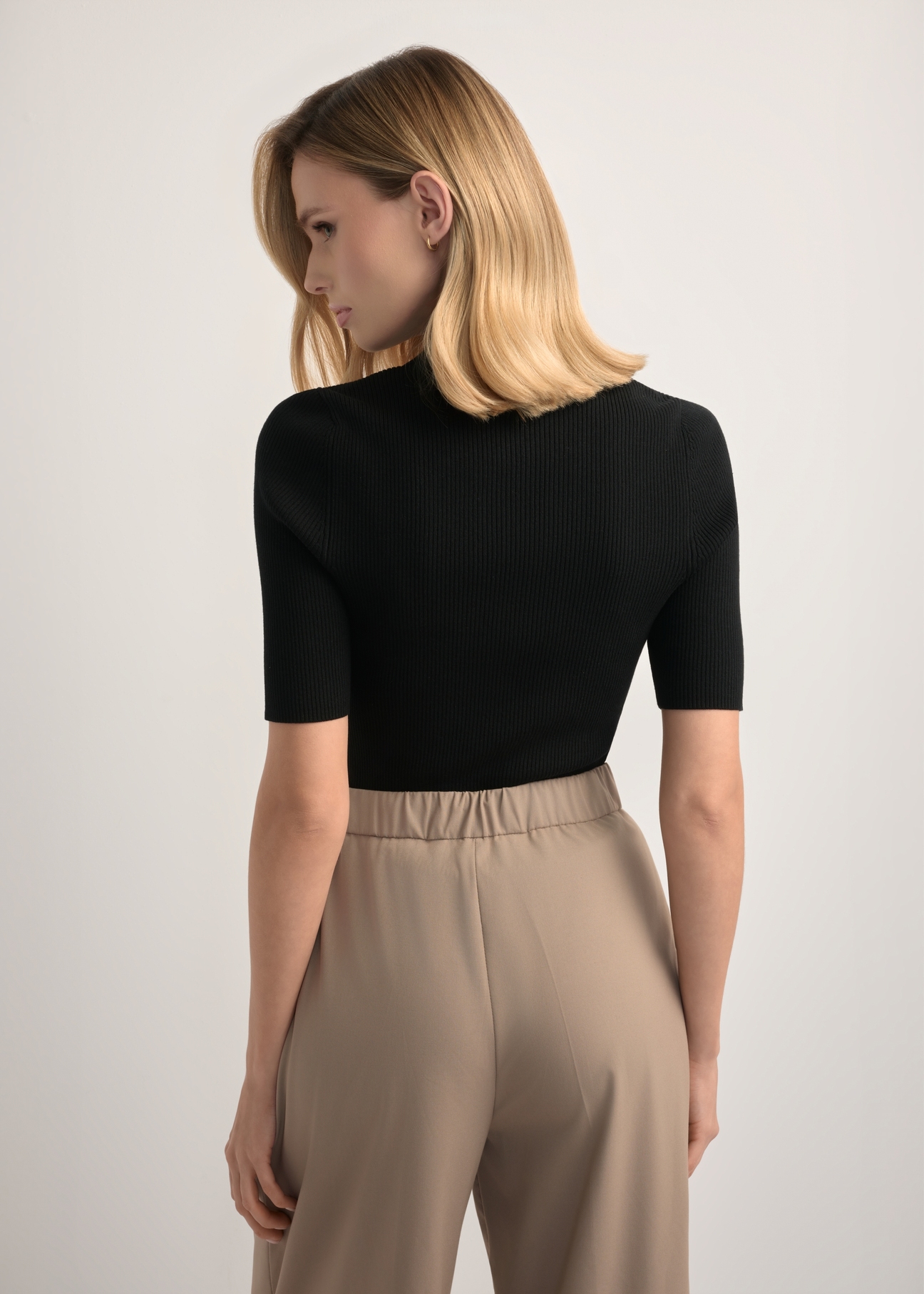 Women's ribbed short-sleeved blouse BLUDT-0200-99(W26), back view of the product on the model. Half of the silhouette visible.