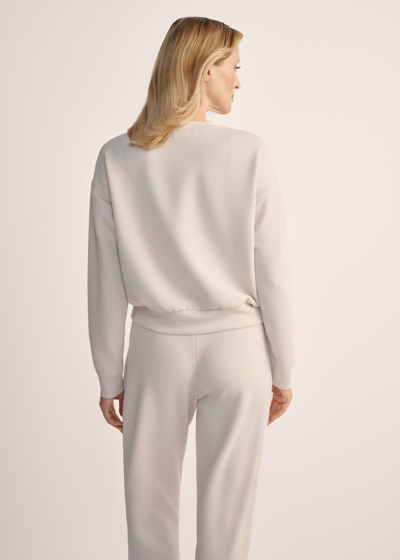 Light beige women's sweatshirt BLZDT-0119-80(Z25), back view of the product on the model. Half of the silhouette visible.