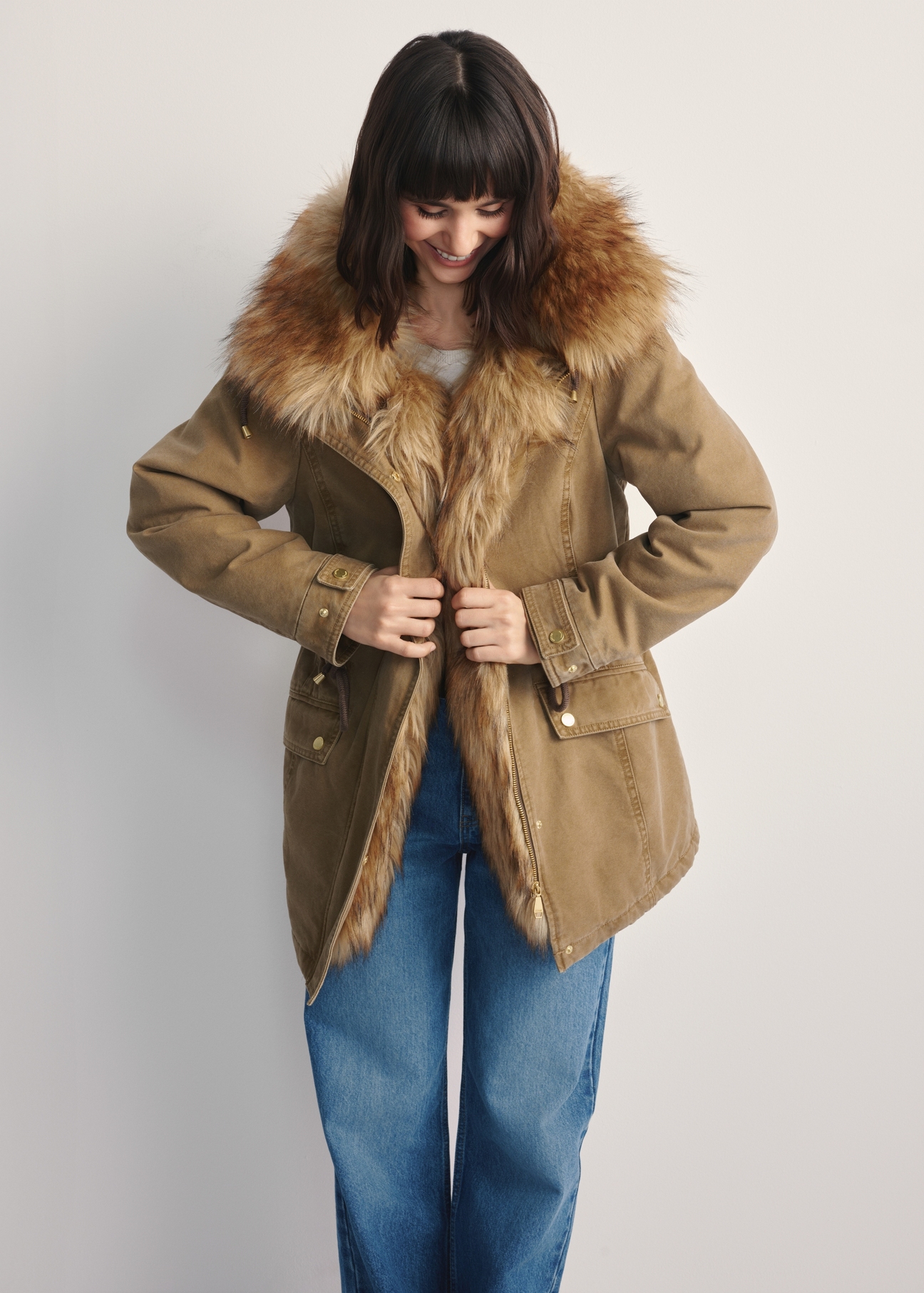 Beige women's fur jacket KURDT-0612-81(Z25) - front view of the product on a model against a white background. Knee-length silhouette visible.
