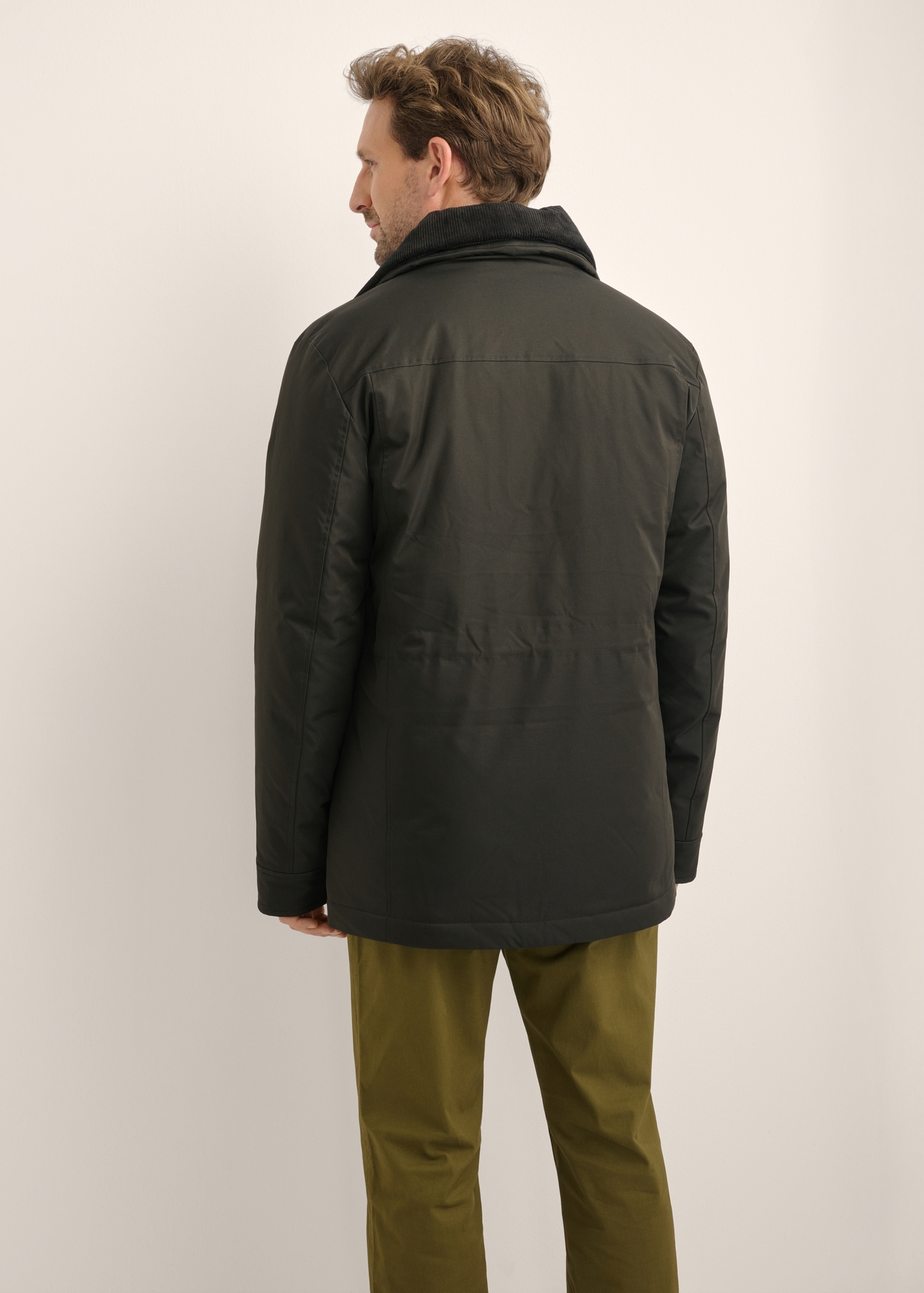 Black men's jacket KURMT-0442-99(Z26), product view from the back on the model. Half of the silhouette visible.
