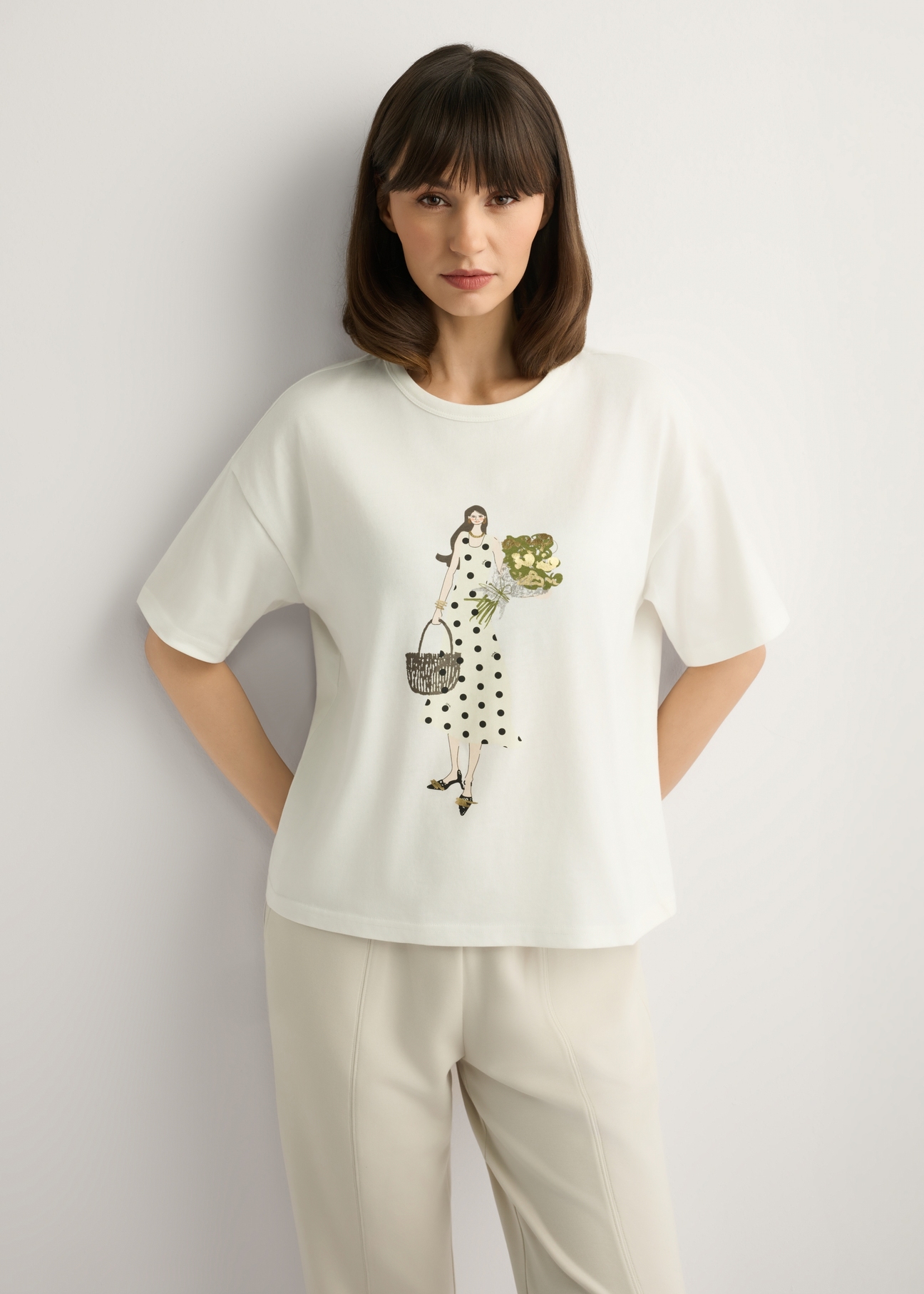 Cream women's T-shirt with print TSHDT-0161-0B(W26), front view of the product on the model. Half of the silhouette visible.