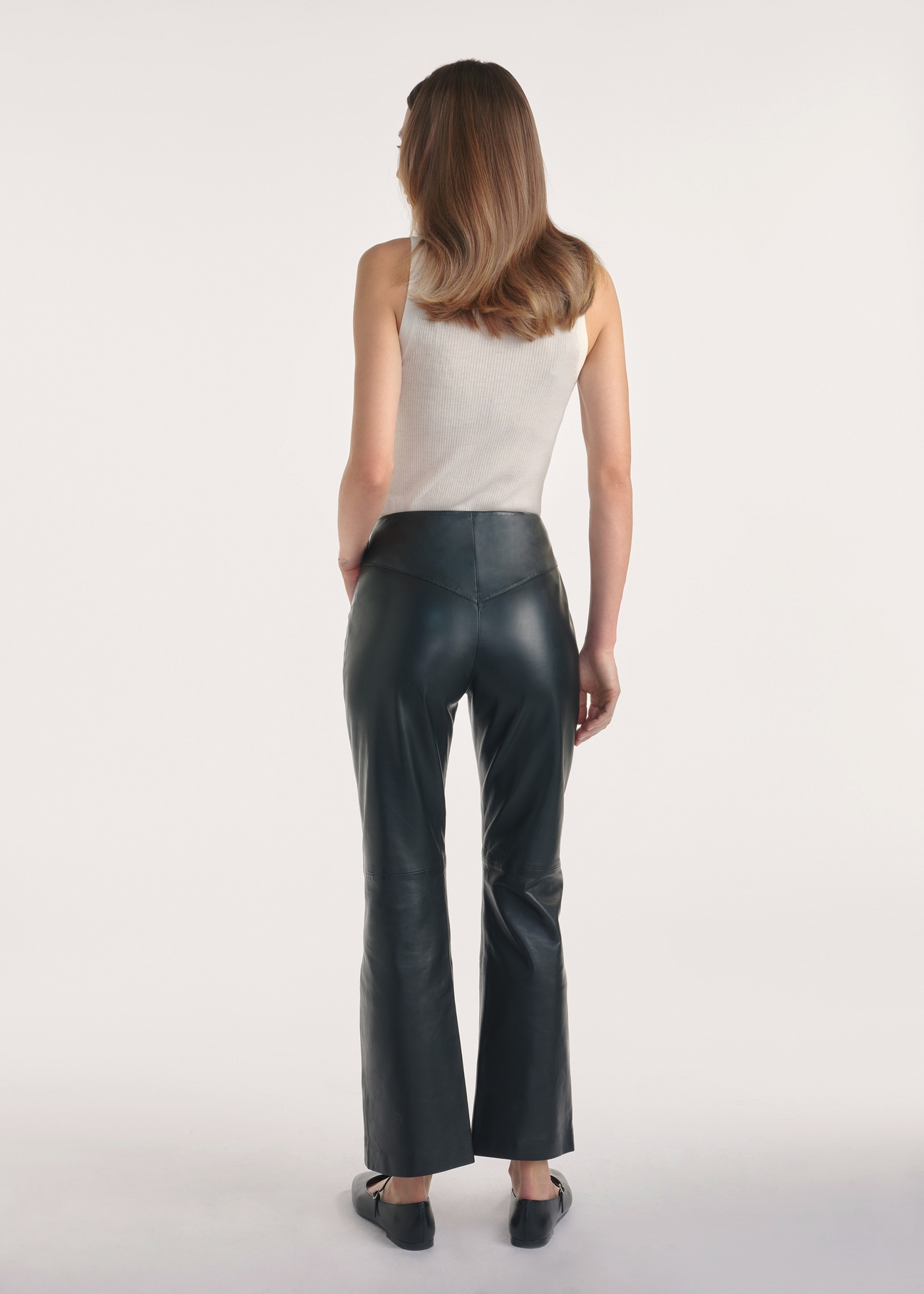 Black women's leather trousers SPODS-0046-2038(Z25), product visible from the back on the model, the entire silhouette is visible.