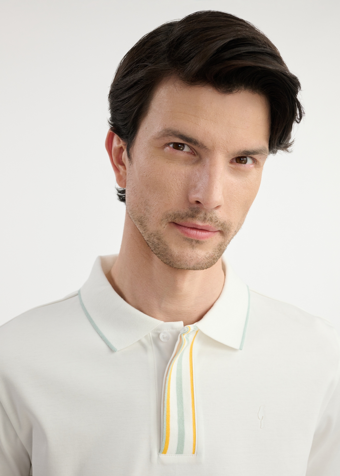 Cream men's polo shirt POLMT-0073-12(W25) - close-up of detail on model on white background.