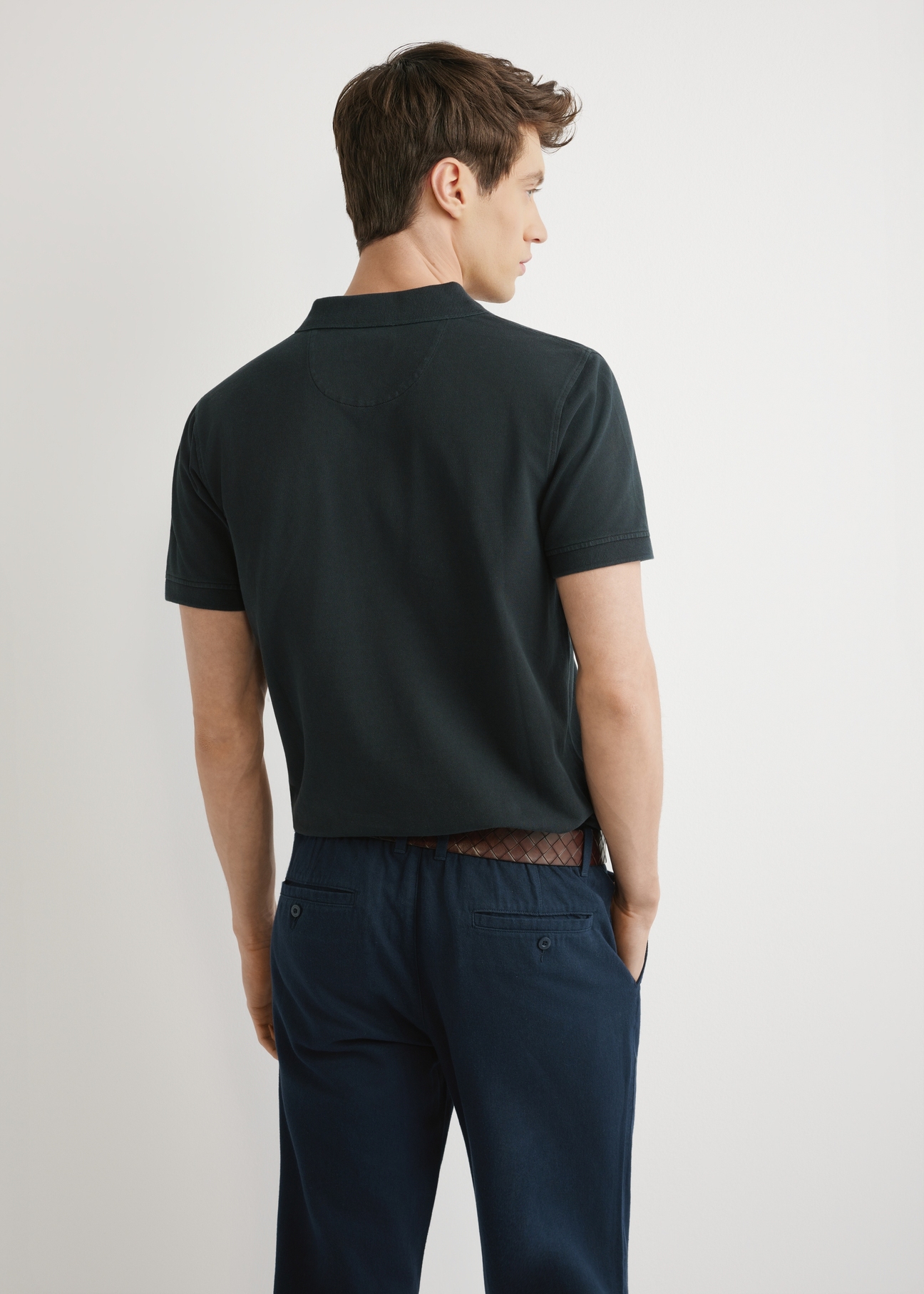 Men's black polo shirt POLMT-0055A-99(W26), back view of the product on the model. Half of the silhouette visible.