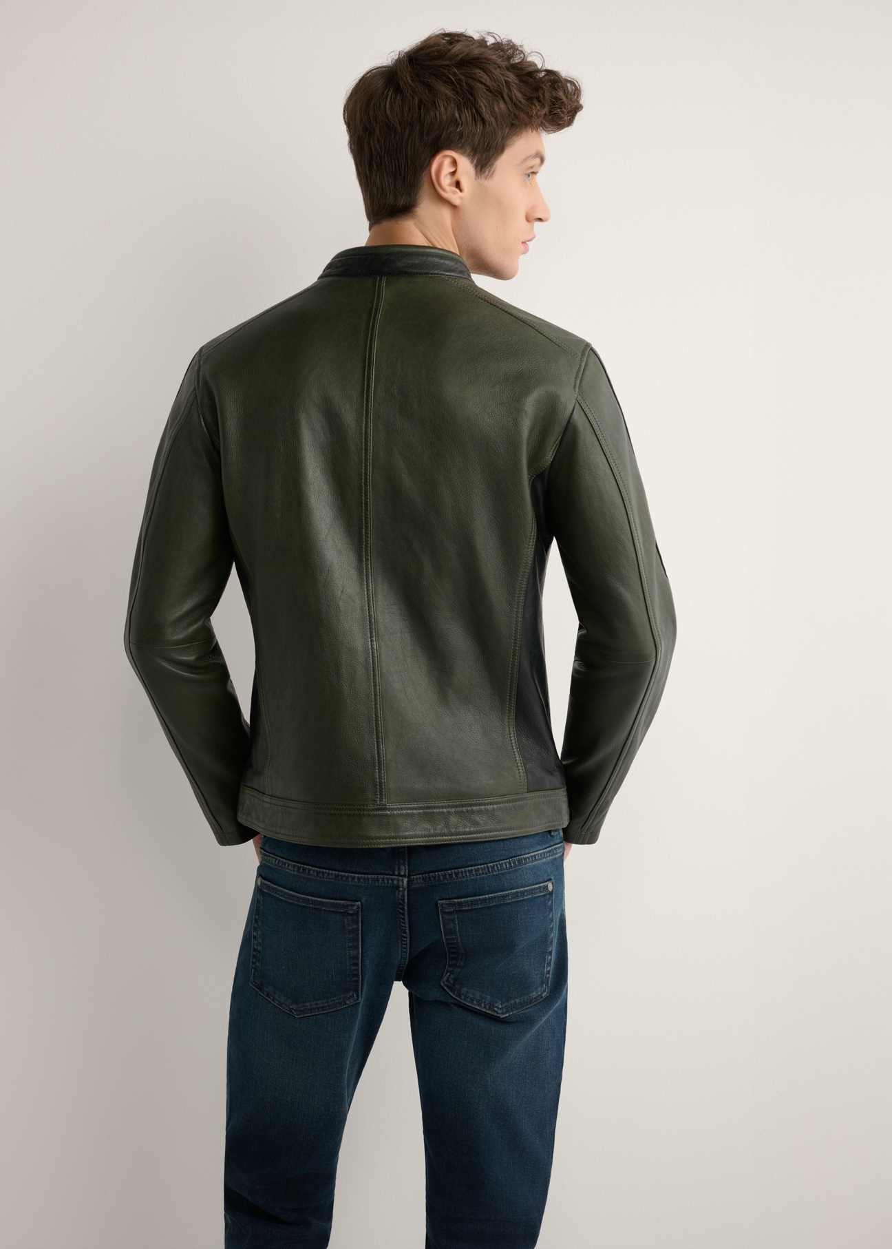 Men's khaki leather jacket KURMS-0399-8D(W26) - back view of the product, on a model, against a light background. Half of the silhouette visible.