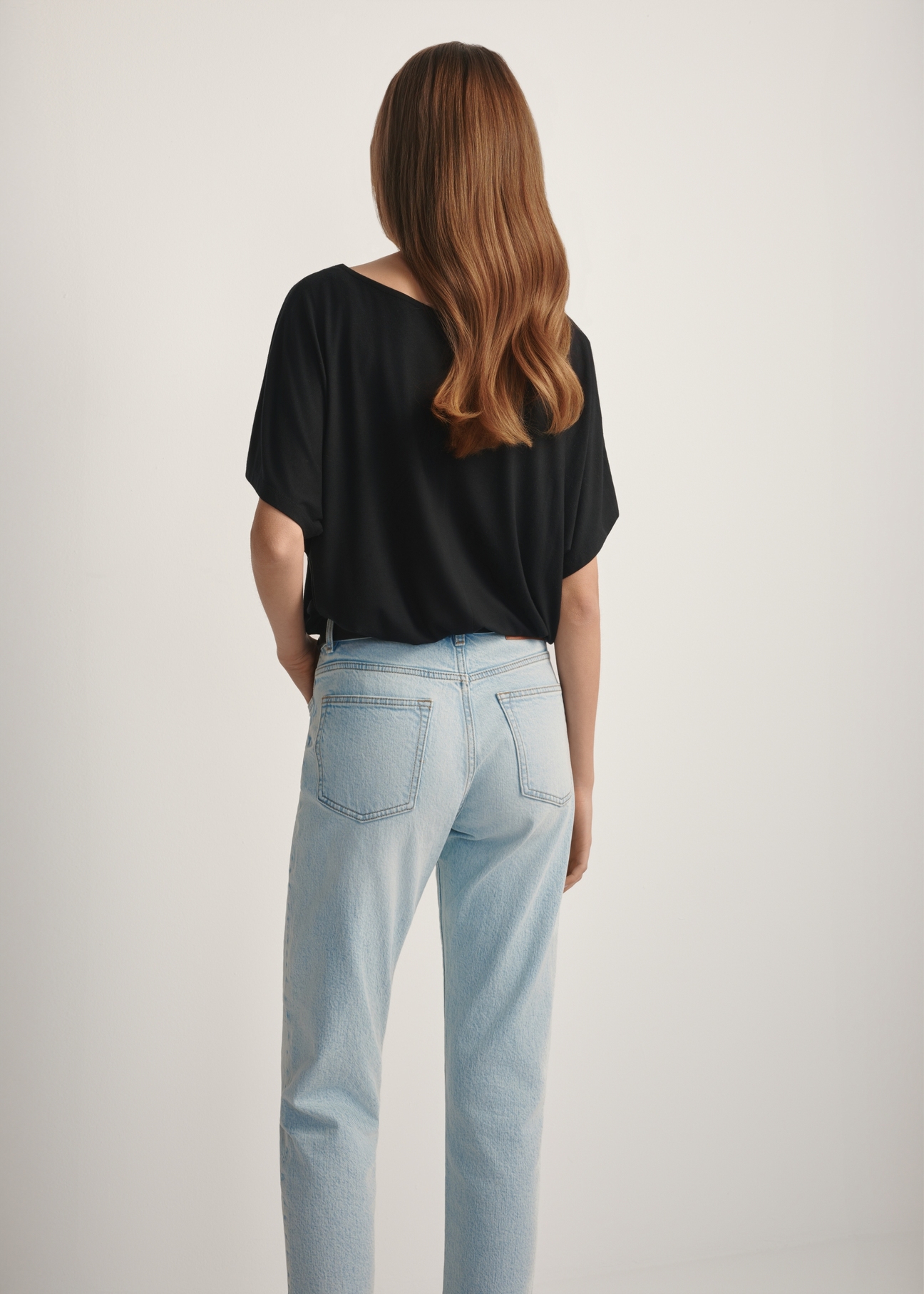 Women's black ribbed blouse BLUDT-0170-99(W25), back view of the product on the model. Half of the silhouette visible.