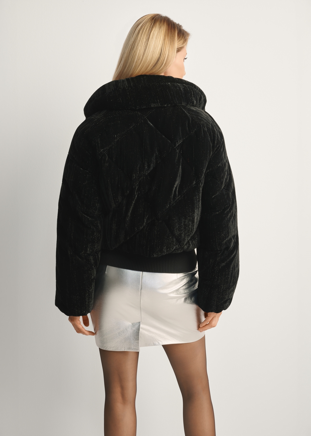 Short shiny women's jacket KURDT-0607-99(Z25), product view from the back on the model, half of the silhouette visible.