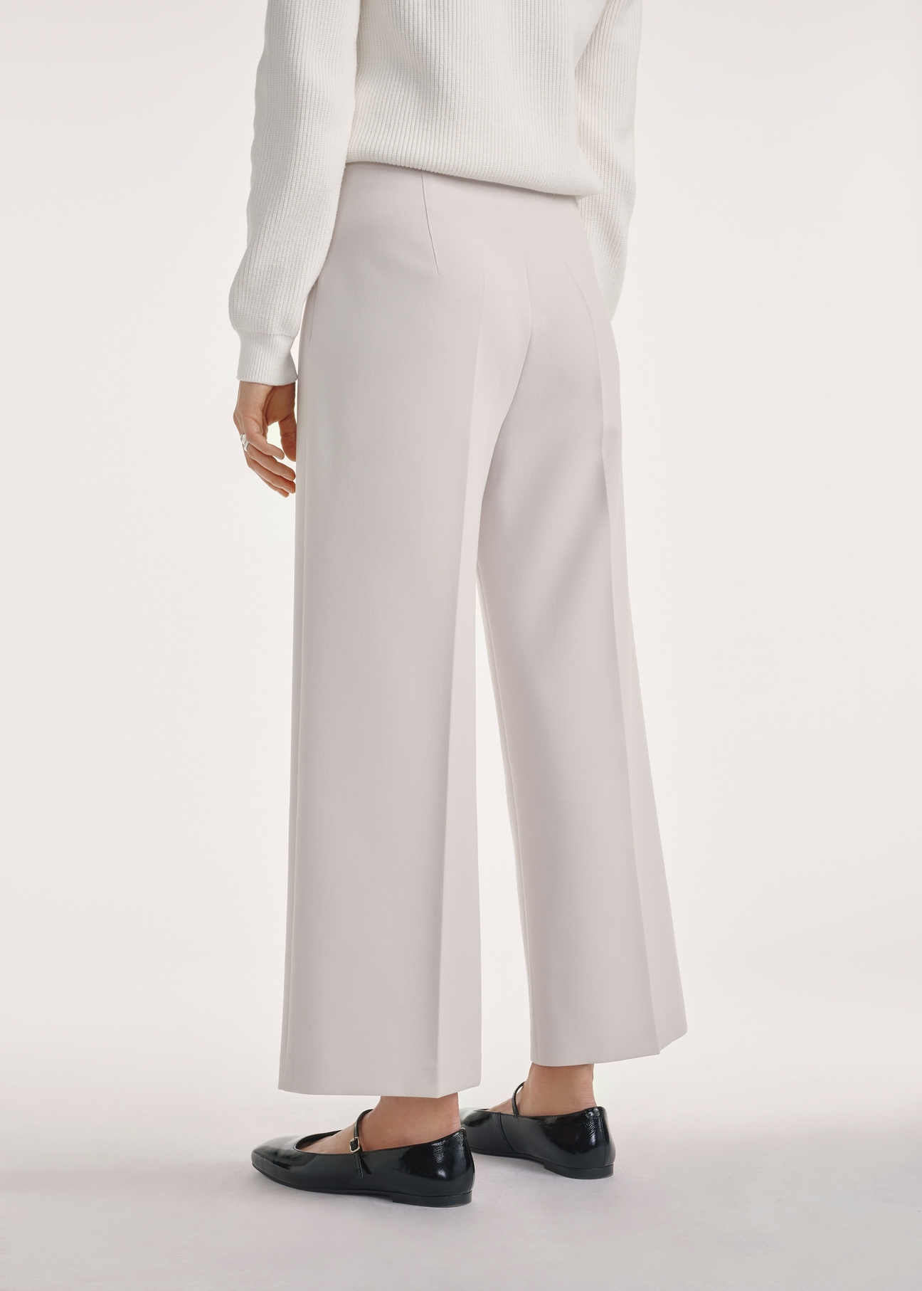 Light beige wide women's trousers SPODT-0118-80(Z25), product view from the back on the model, half of the silhouette visible.
