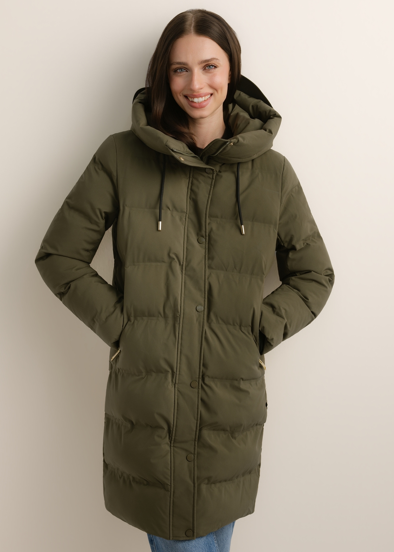 Women's khaki winter jacket KURDT-0700-8D(Z26), front view of the product on the model. Half of the silhouette visible.
