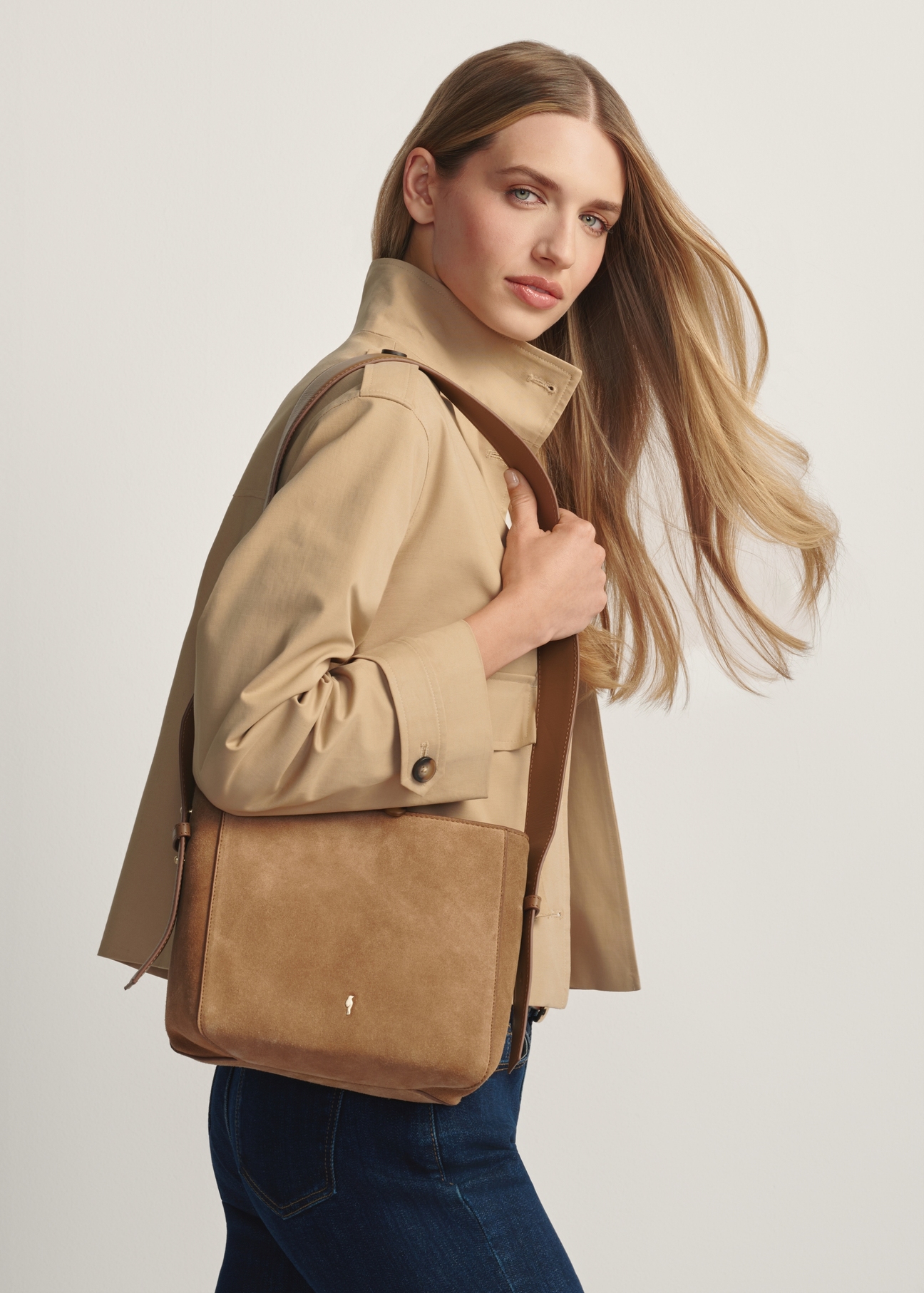 Beige leather handbag TORES-1251-1B(W26) - front view of the product, on a model, against a light background. Knee-length silhouette visible.