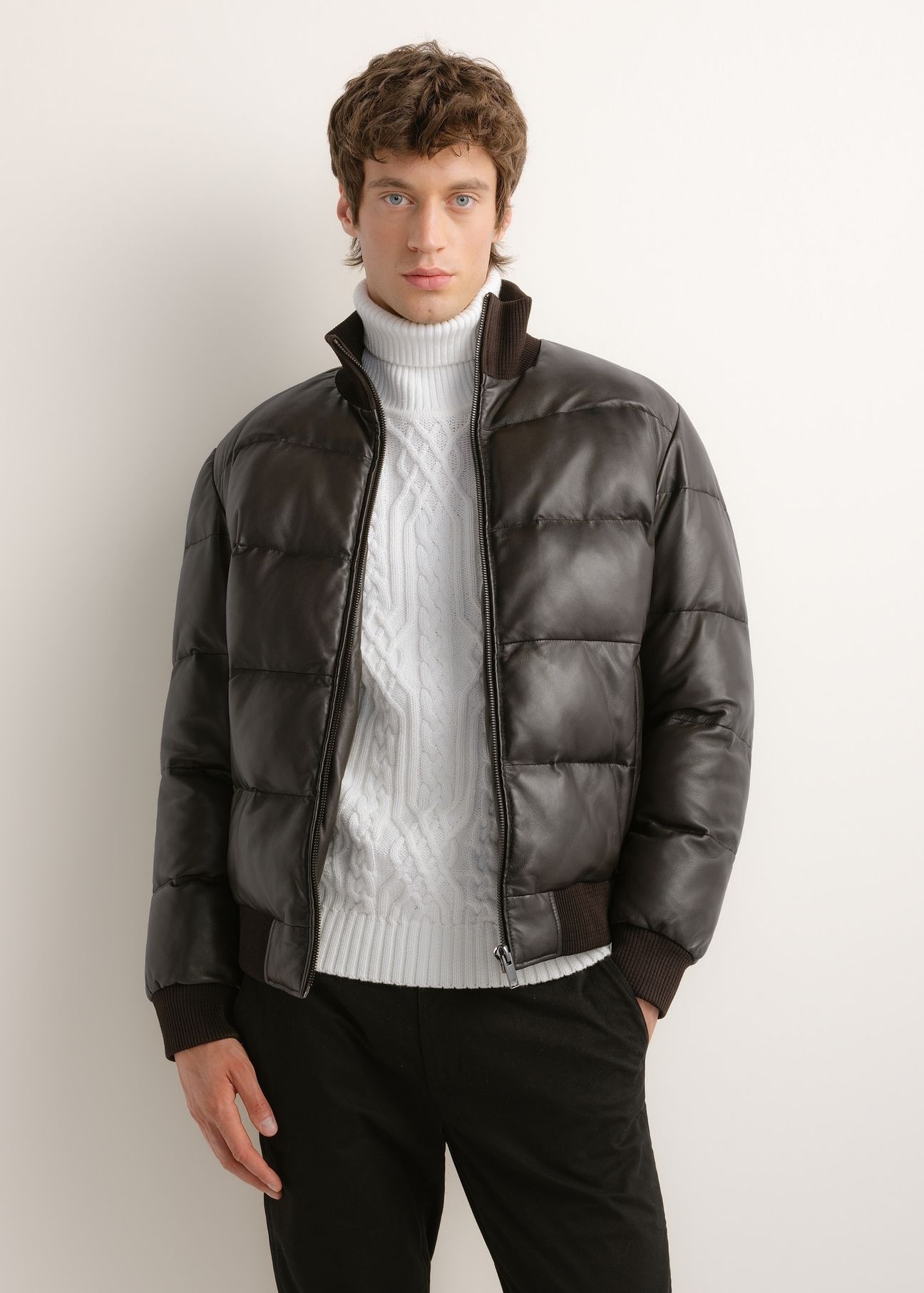 Men's dark brown leather jacket with a stand-up collar (model KURMS-0428-1I(Z26)); front view on a model, showing half of the figure.