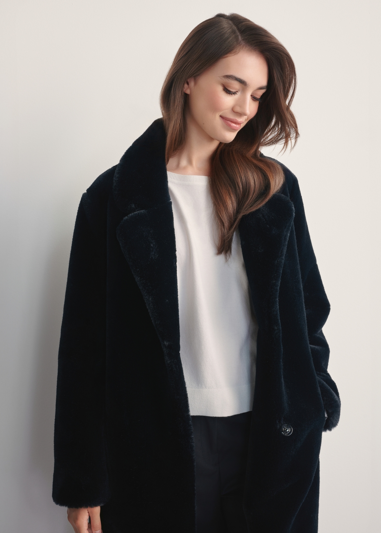 Women's faux fur coat with belt FUTDP-0002A-99(Z25), front view of the product on the model, half of the silhouette visible.