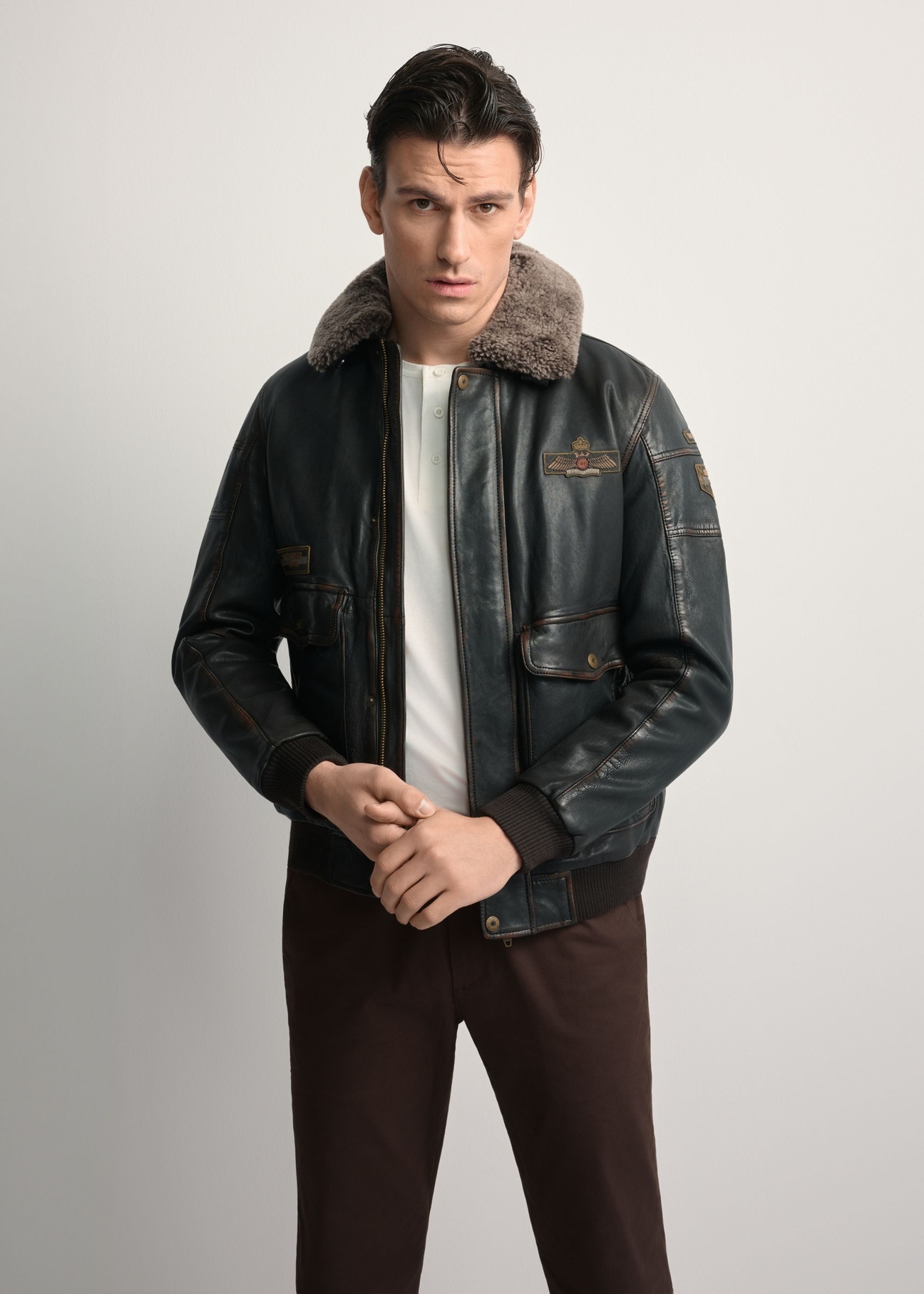 Brown leather jacket with collar KURMS-0380-1I(Z26), front view of the product on the model. Half of the silhouette visible.