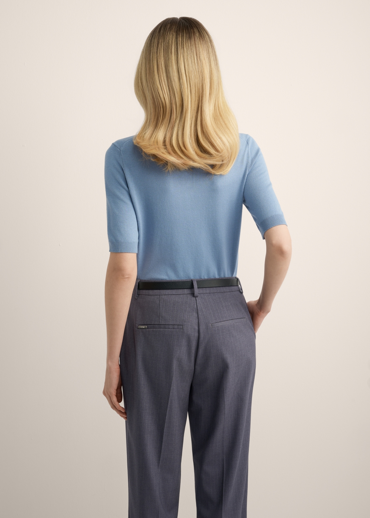 Thin blue sweater with short sleeves SWEDT-0268-7B(Z26), back view of the product on the model. Half of the silhouette visible.