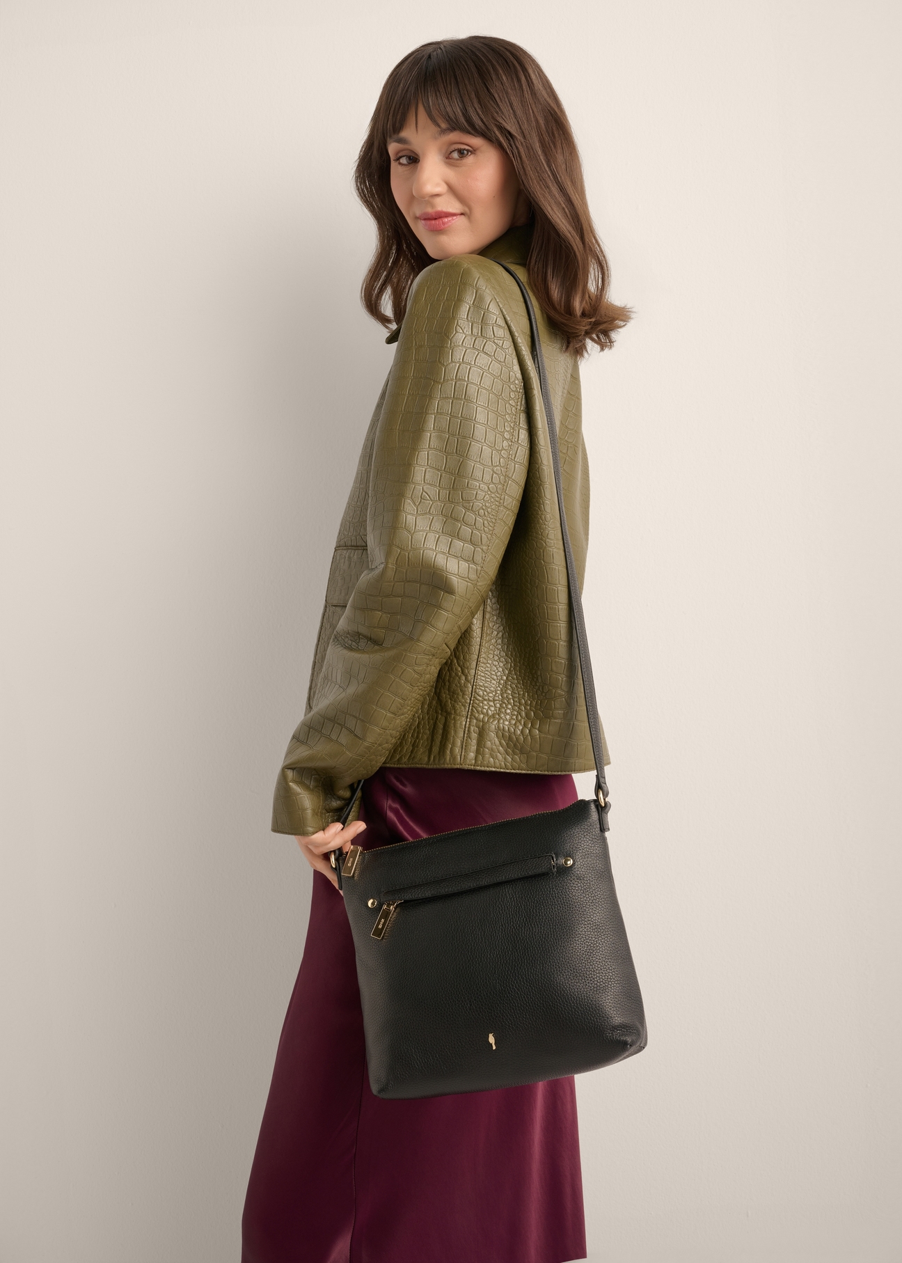 Women's black handbag made of genuine pea leather TORES-1425-9I(Z26), front view of the product on a model. Half of the silhouette visible.