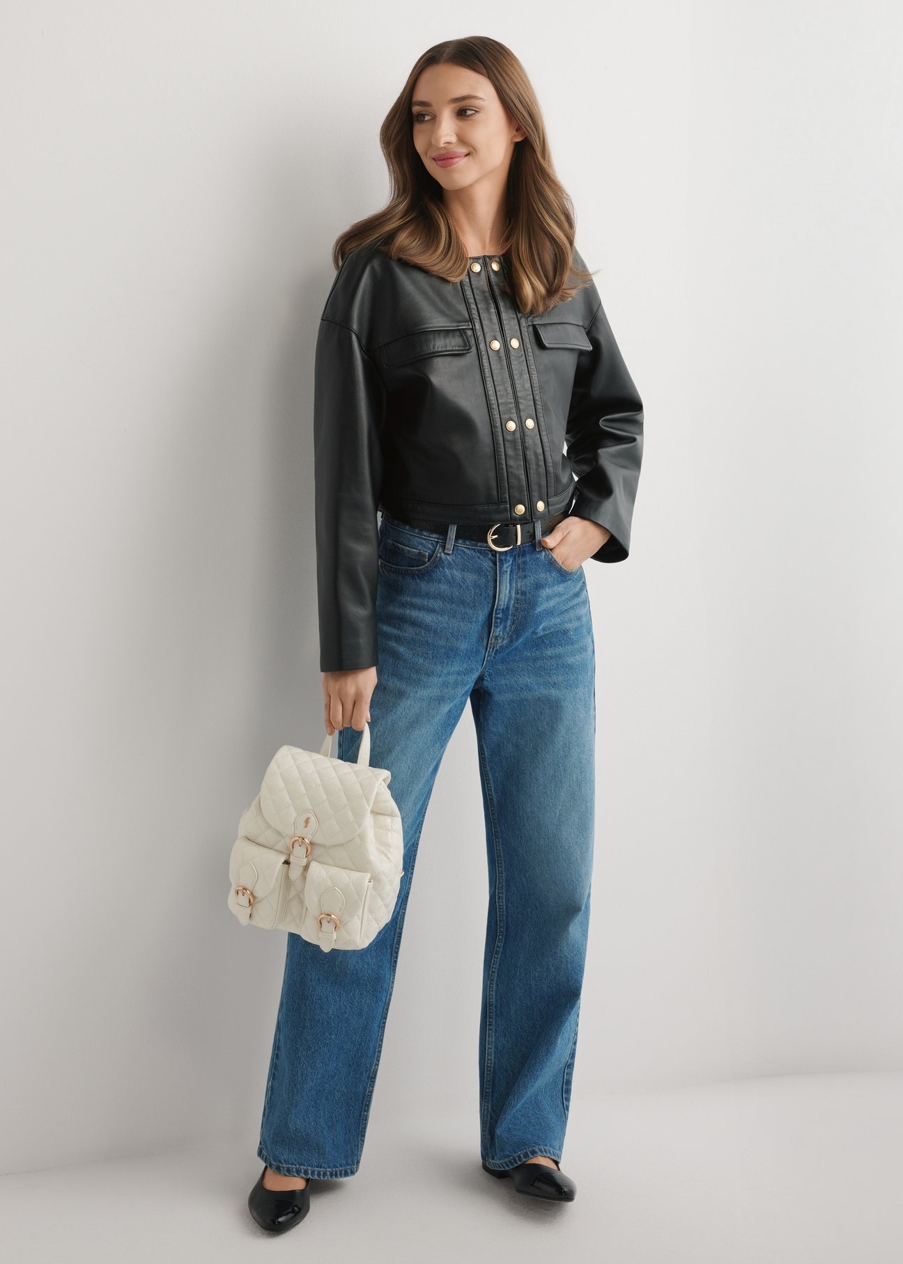 Cream TOREC-1195-0A(W26) women's quilted backpack - front view of the product, held by the model, against a light background. The entire silhouette is visible.