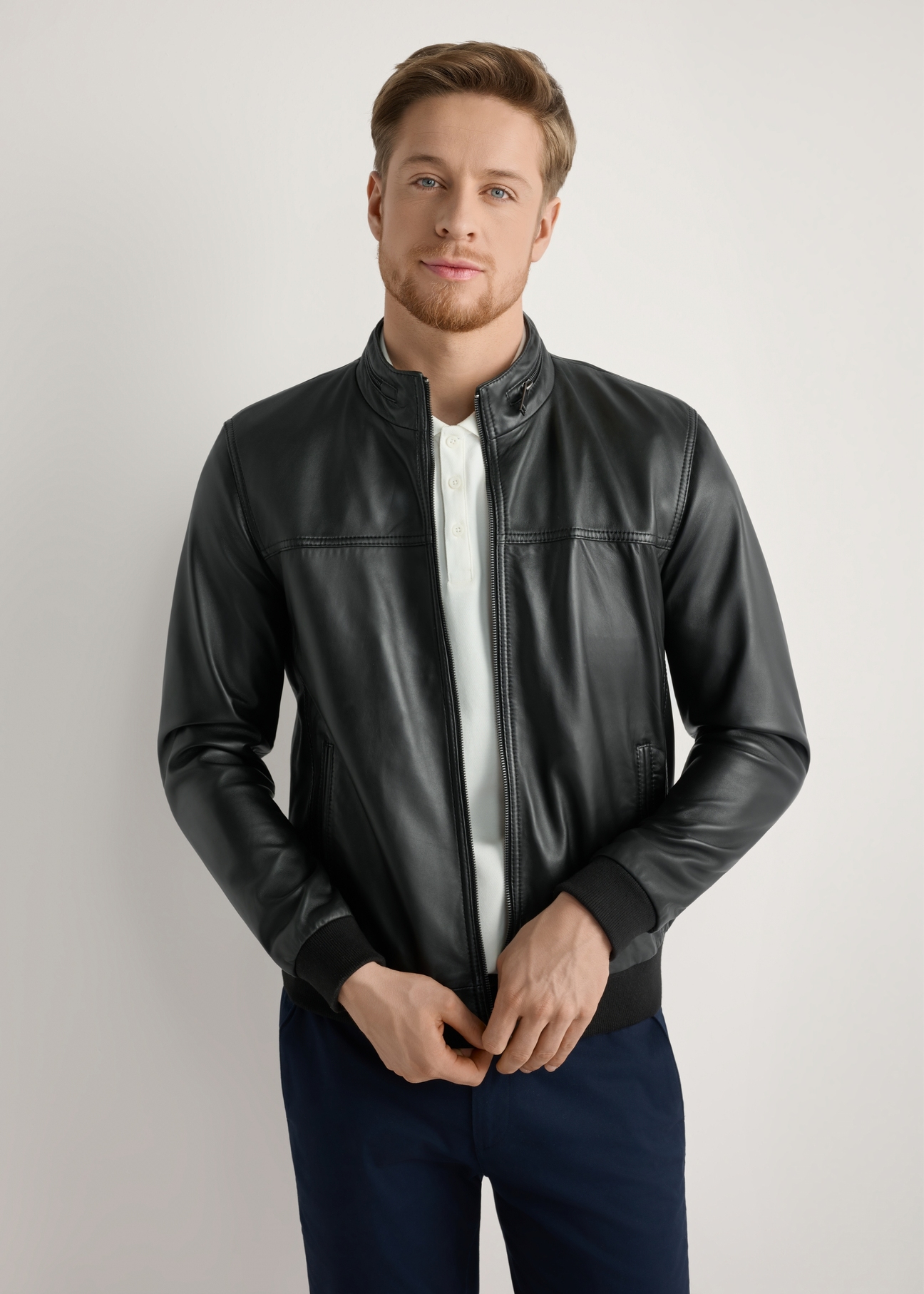 Men's black leather jacket KURMS-0392-99(W26) - front view of the product, on a model, against a light background. Half of the silhouette visible.