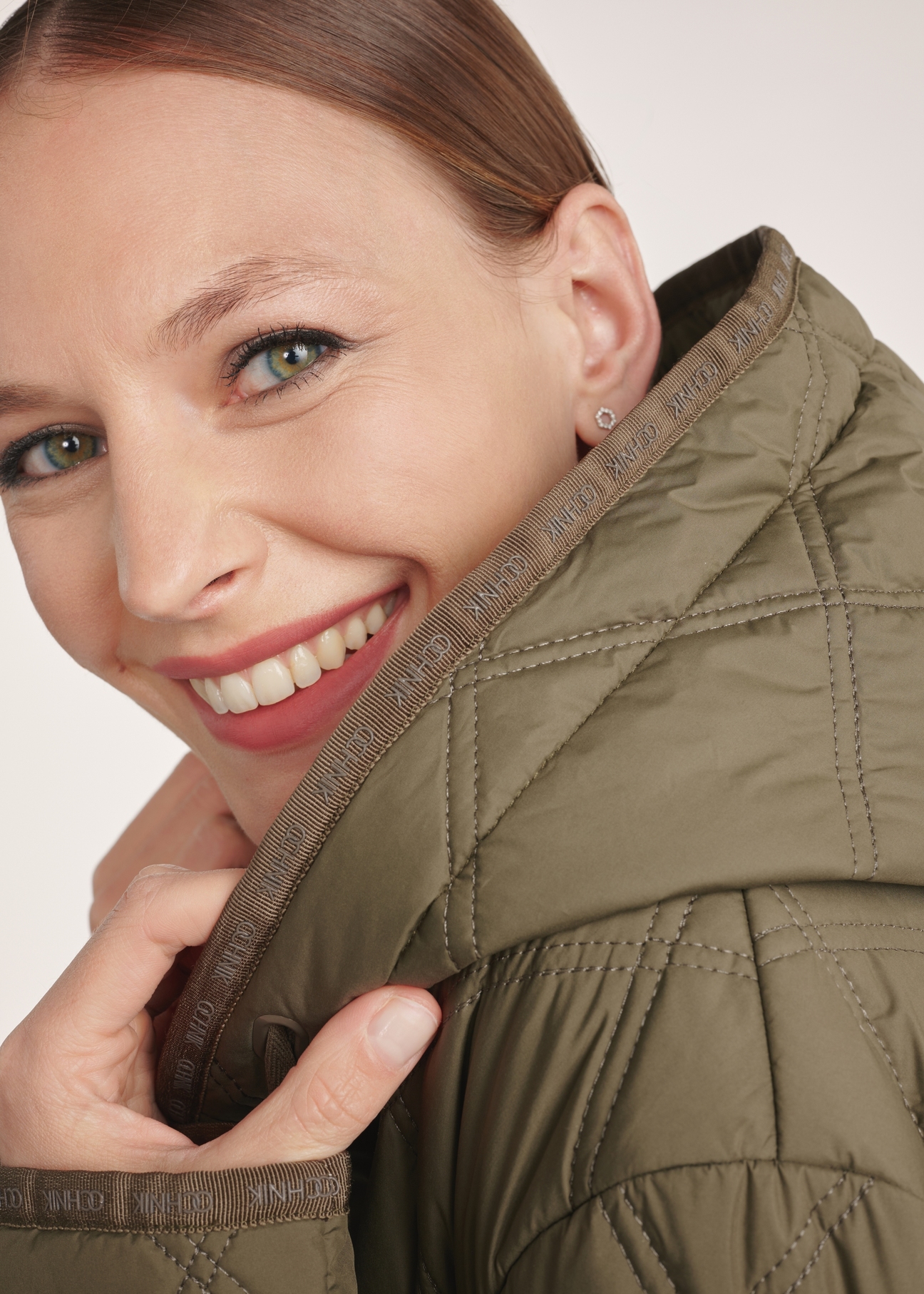 Olive quilted women's jacket KURDT-0579-57(Z25), close-up of the product detail on the model, face visible.