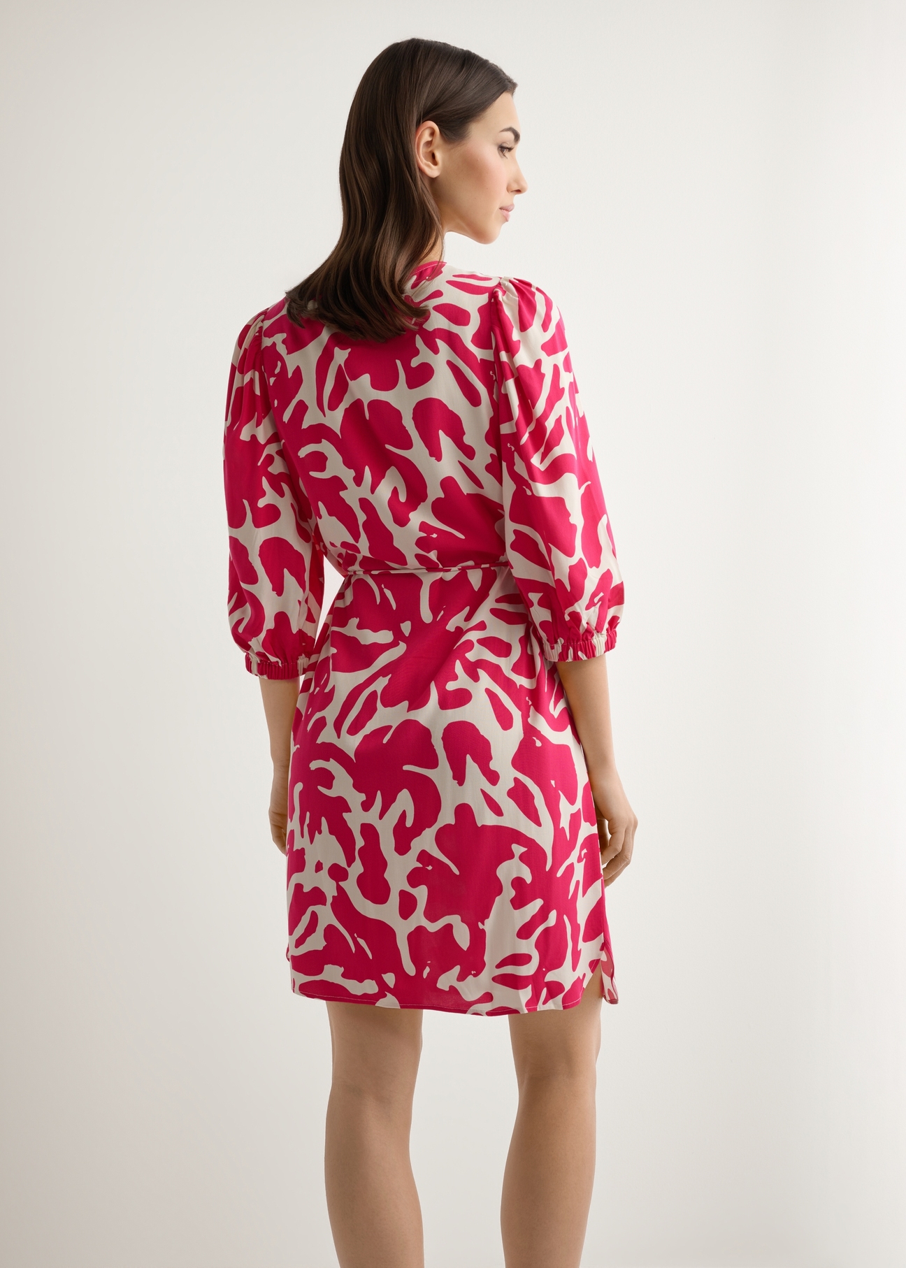 Pink floral viscose dress SUKDT-0271-5P(W26), back view of the product on the model. Half of the silhouette visible.