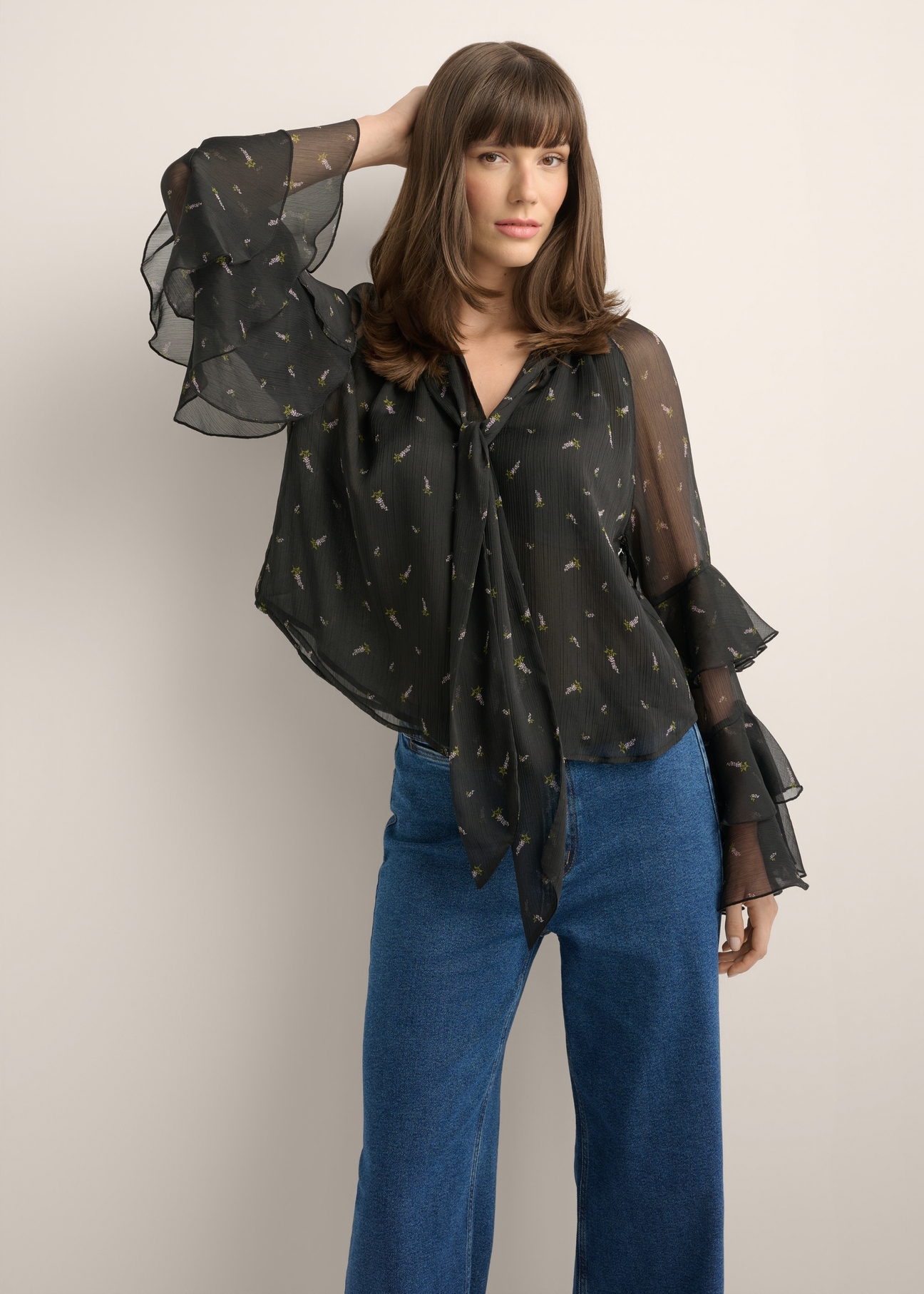 Women's black blouse with a lilac pattern BLUDT-0212-9P(Z26), front view of the product on the model. Half of the silhouette visible.