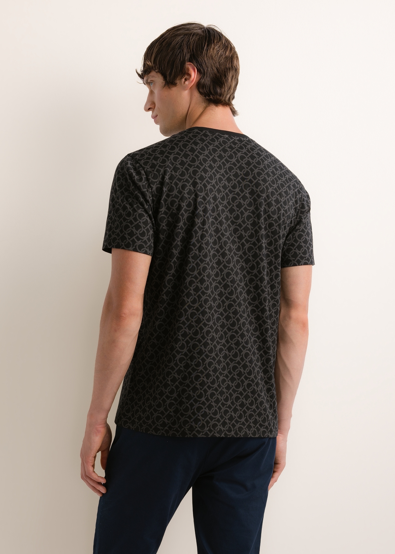 Men's cotton T-shirt with a monogram pattern (TSHMT-0163-99(Z26)); rear view of the product on a model. Half of the figure is visible.