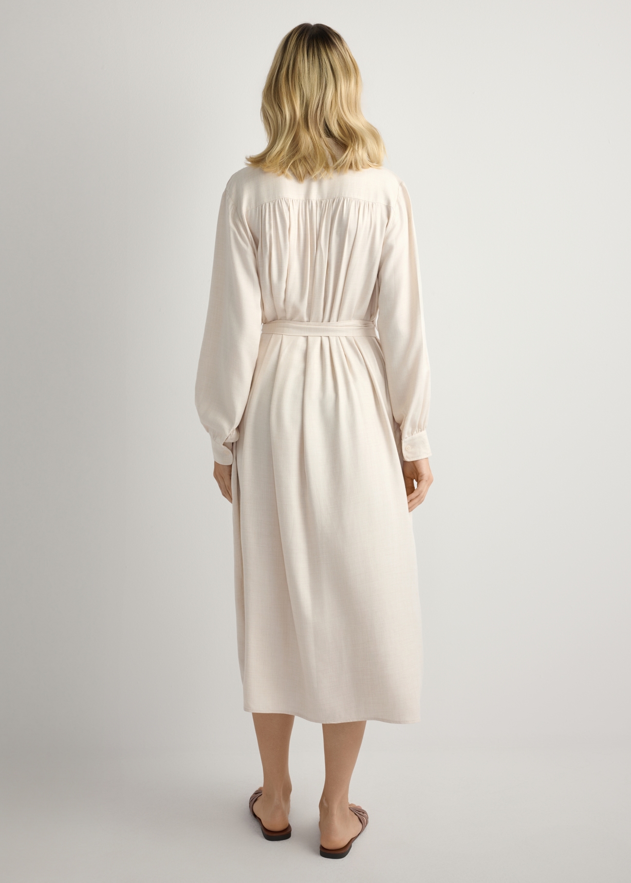 Light beige women's midi dress SUKDT-0269-1A(W26), back view of the product on the model. Half of the silhouette visible.