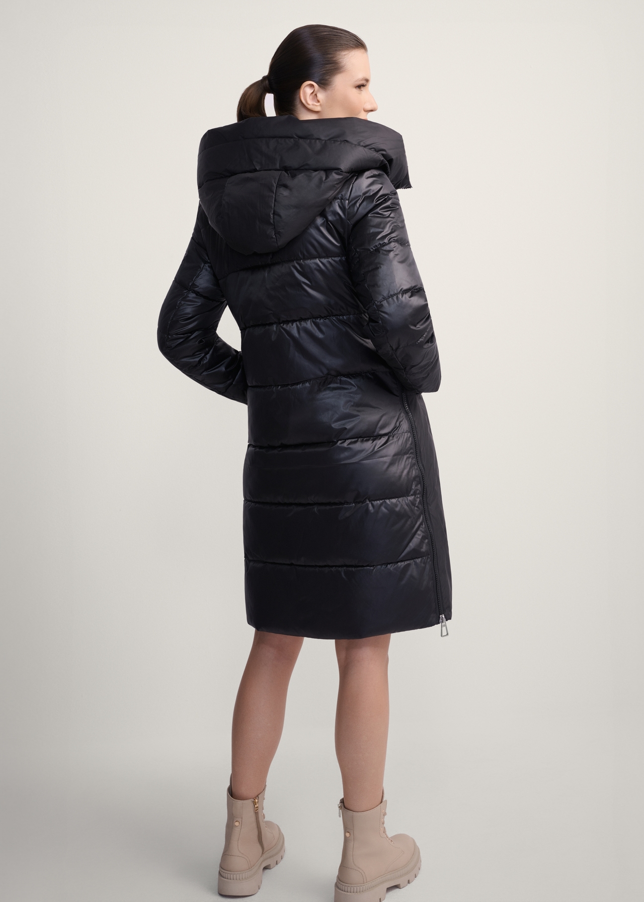 Women's black winter jacket with hood KURDT-0478-99(Z25), product view from the back on the model. Full body visible.
