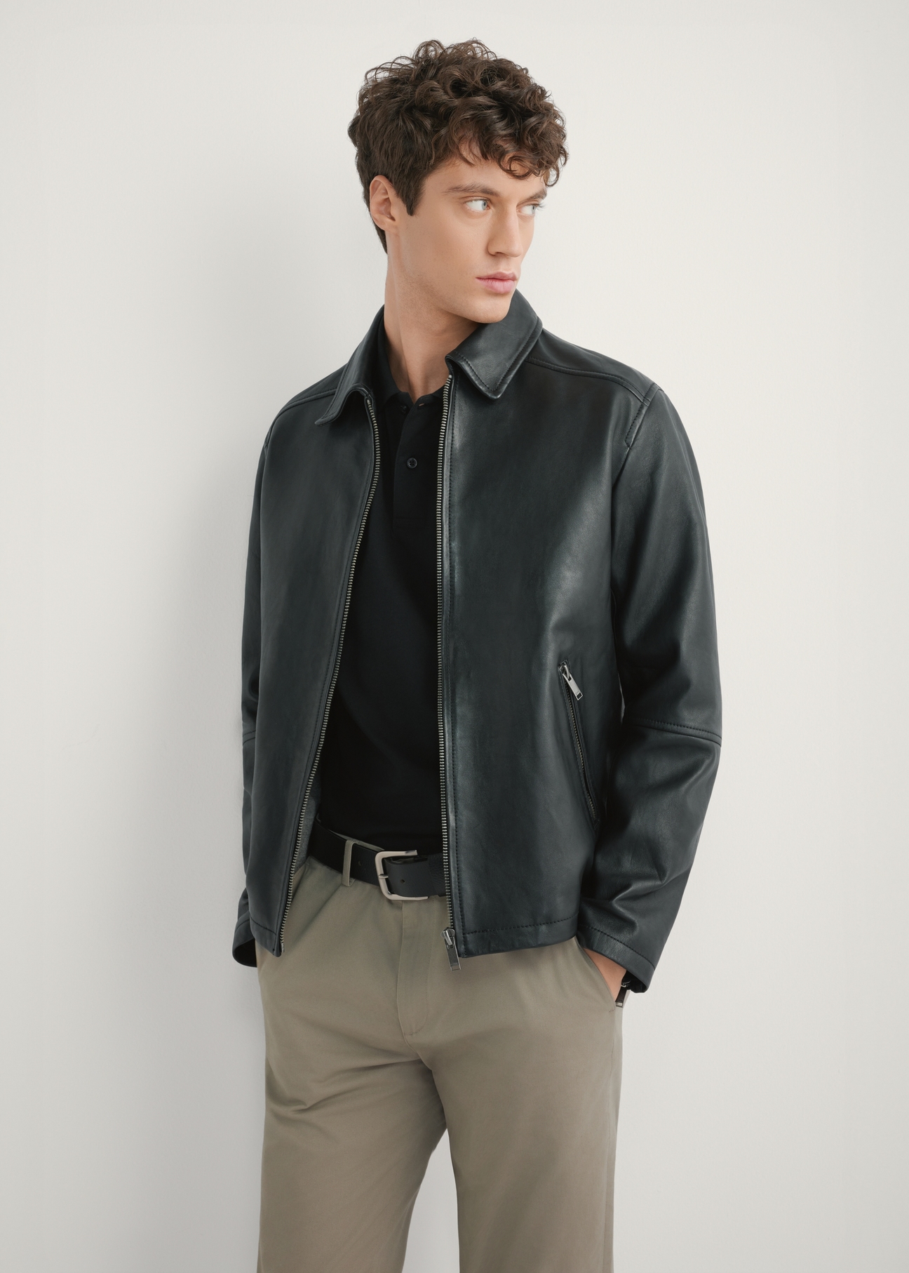 Men's black leather jacket KURMS-0363-99(W26), front product view on model. Half silhouette visible.