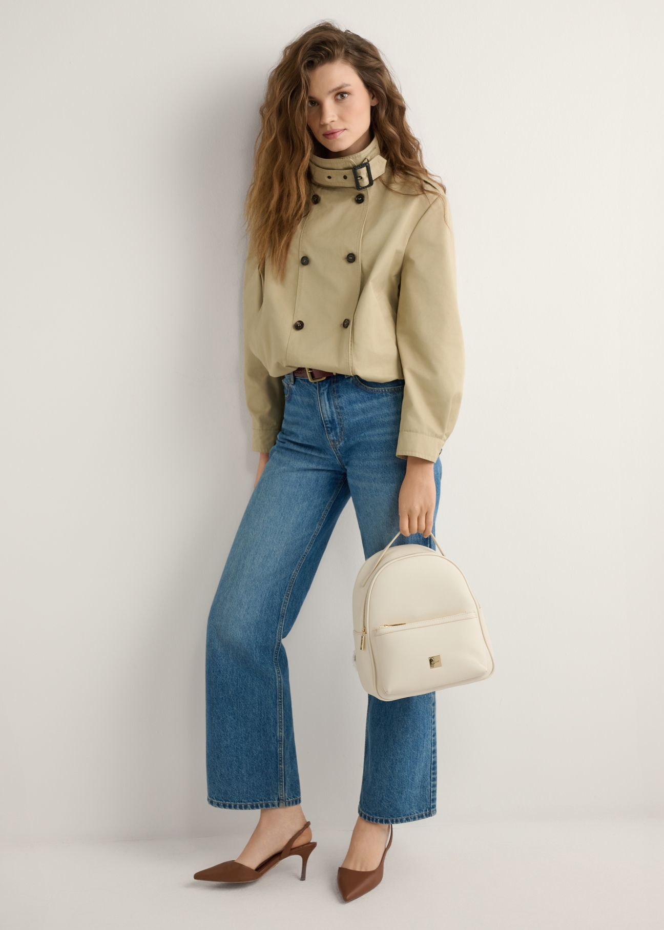 Cream women's medium backpack TOREC-0920-0B(W26), product view in model's hand. Full body visible.