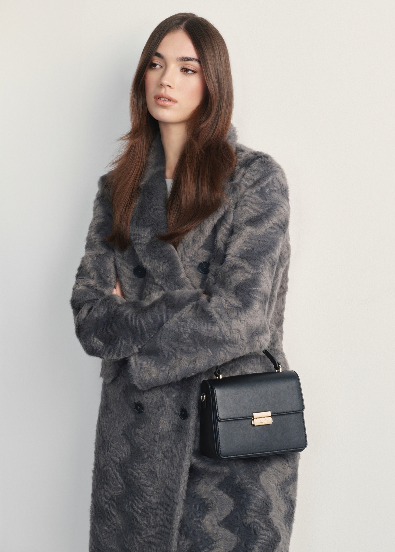 Black women's handbag TOREC-1080-99(Z25) - front view of the product on a model, against a white background. Knee-length silhouette visible.