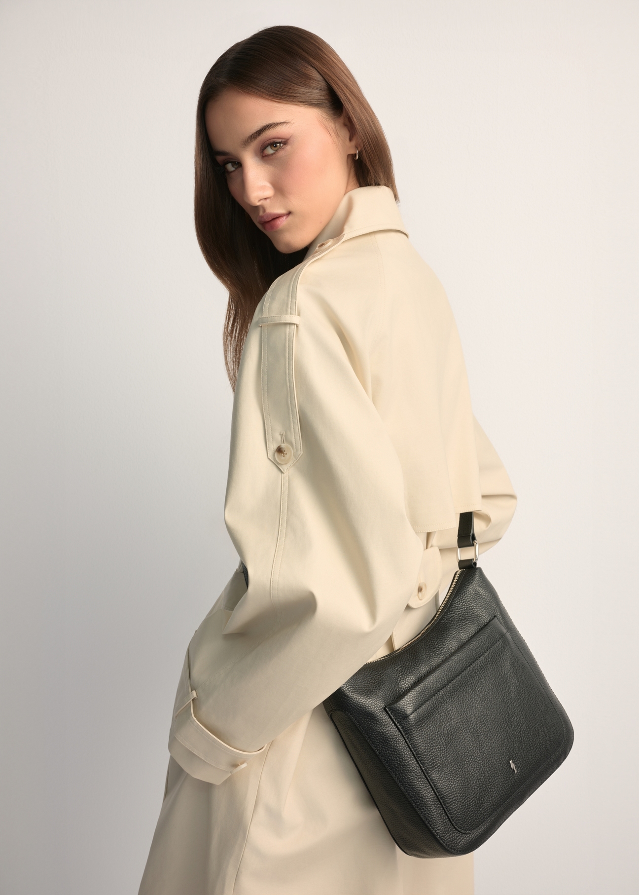 Black leather women's shoulder bag TORES-1219-9I(W26), front view of the product on a model, half of the silhouette visible.