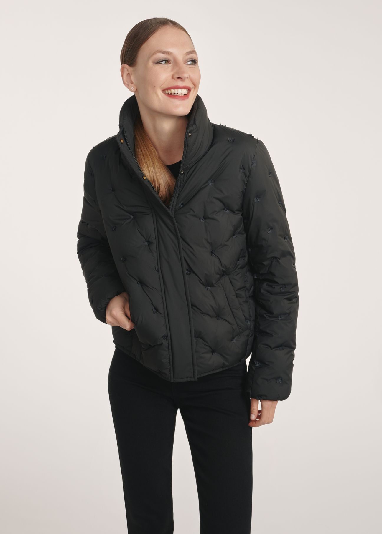 Black women's winter jacket KURDT-0614-99(Z25), front view of the product on the model, half of the silhouette visible.