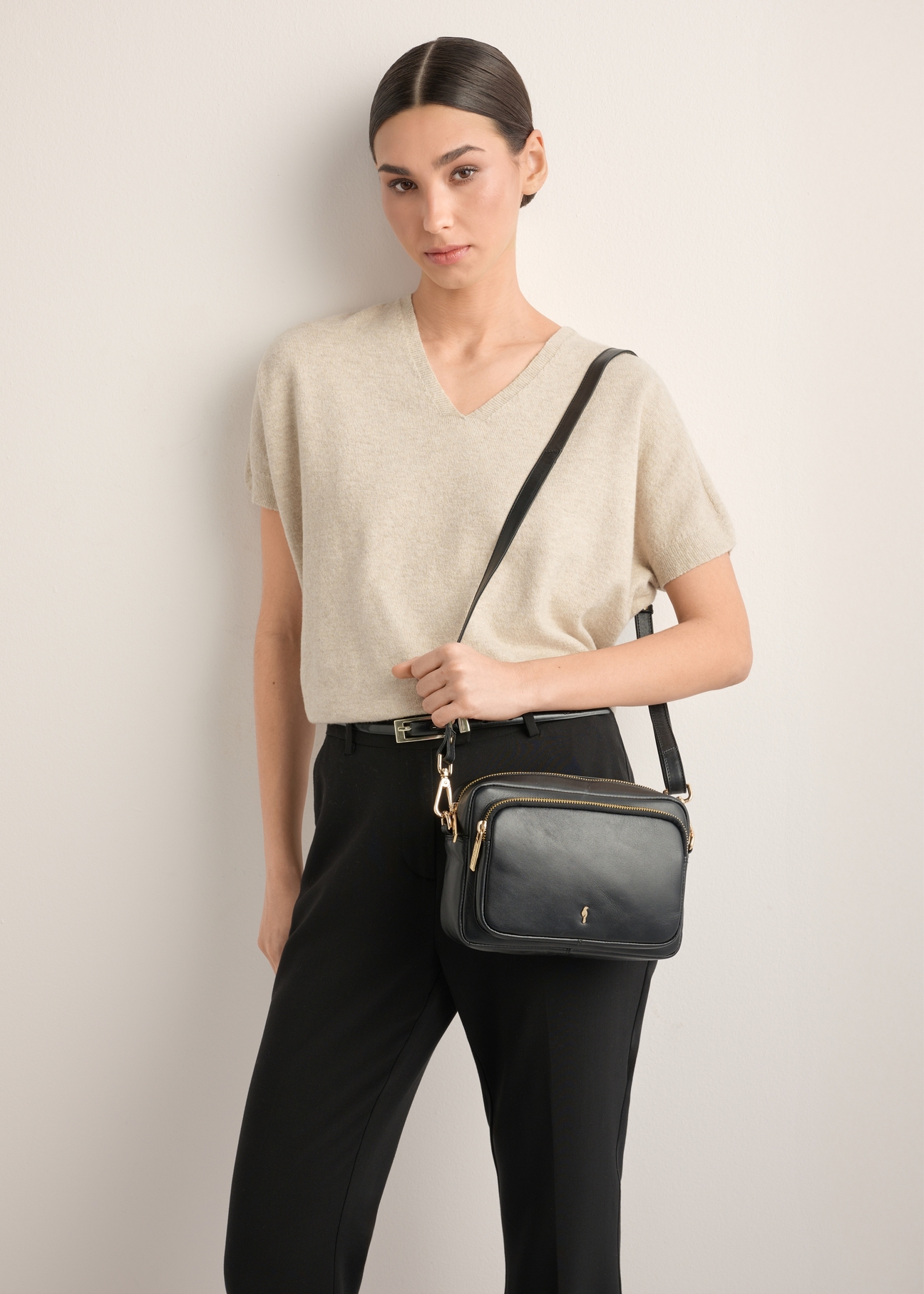 Women's black leather shoulder bag TORES-1331-99(Z26), product view on model's shoulder. Half silhouette visible.