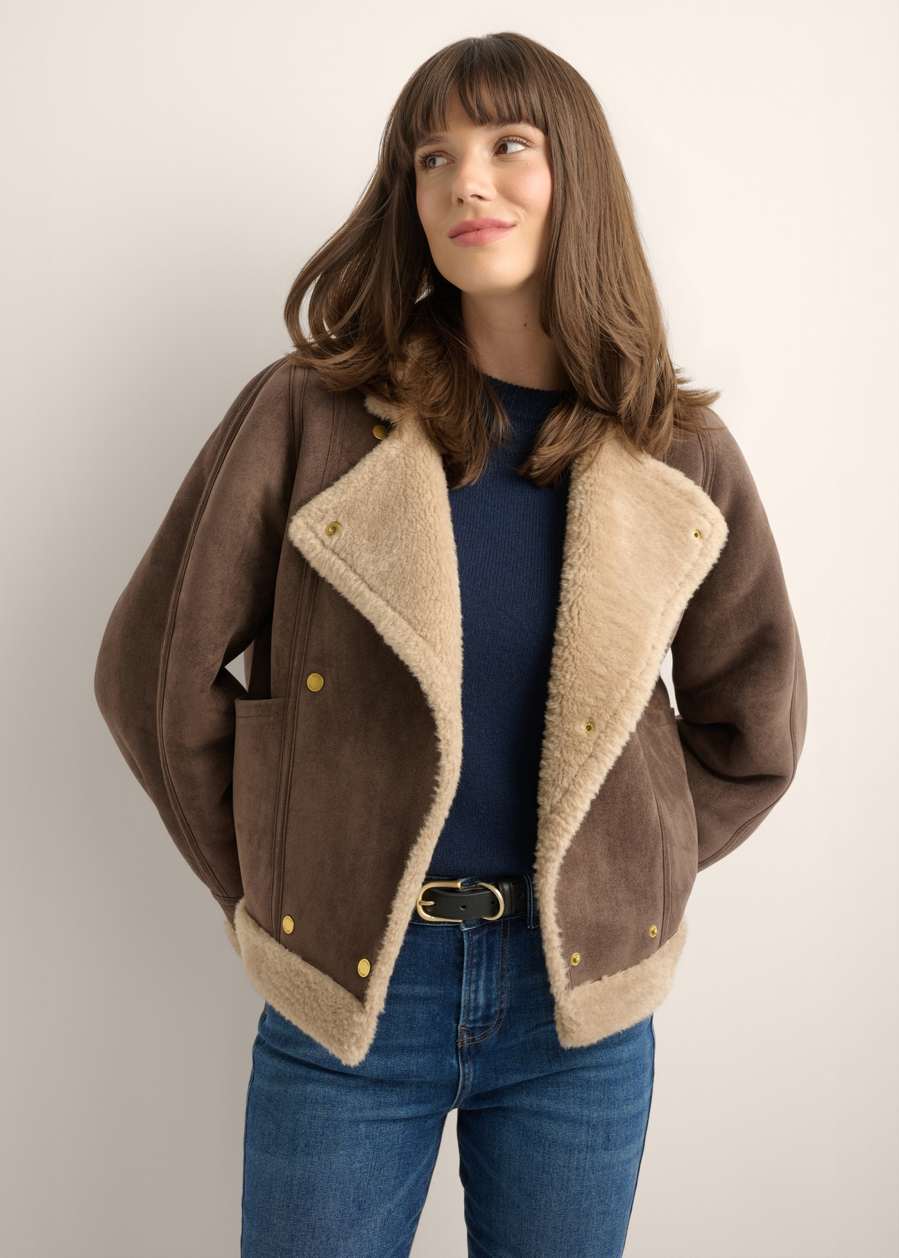 Dark brown short women's sheepskin coat KOZDP-0018-1I(Z26), front view of the product on a model. Half of the silhouette visible.-02