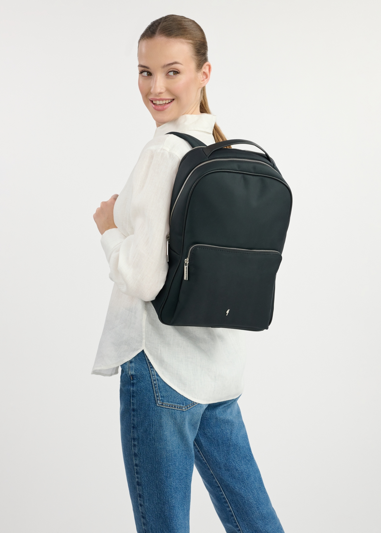Black large women's backpack TOREN-0298-99(W25), front view of the product on a model. Half of the silhouette visible.