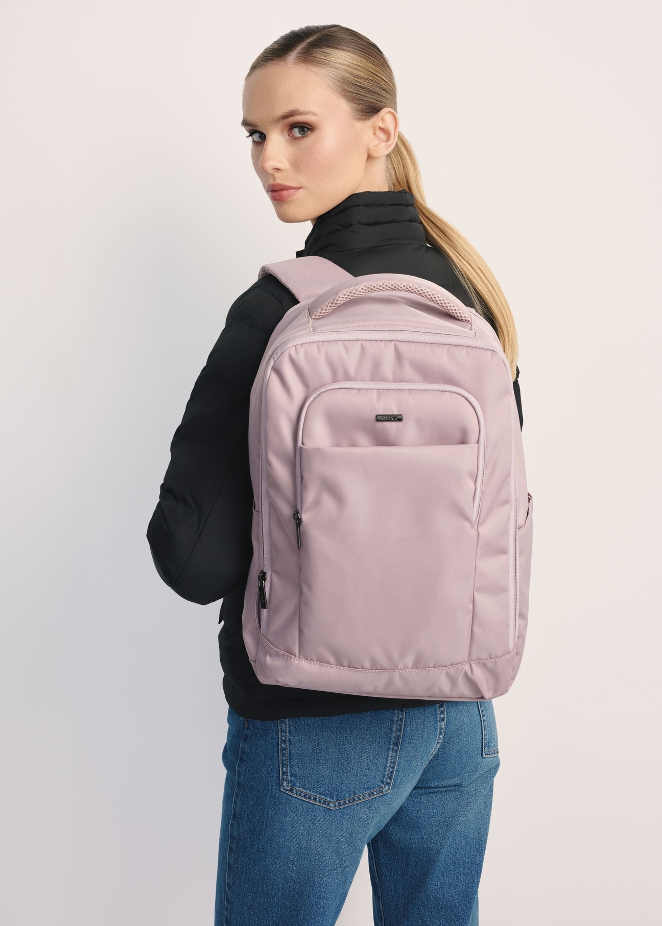 Pink backpack PLCMN-0014 A-31(Z 25), front view of the product on the model, half of the silhouette visible.