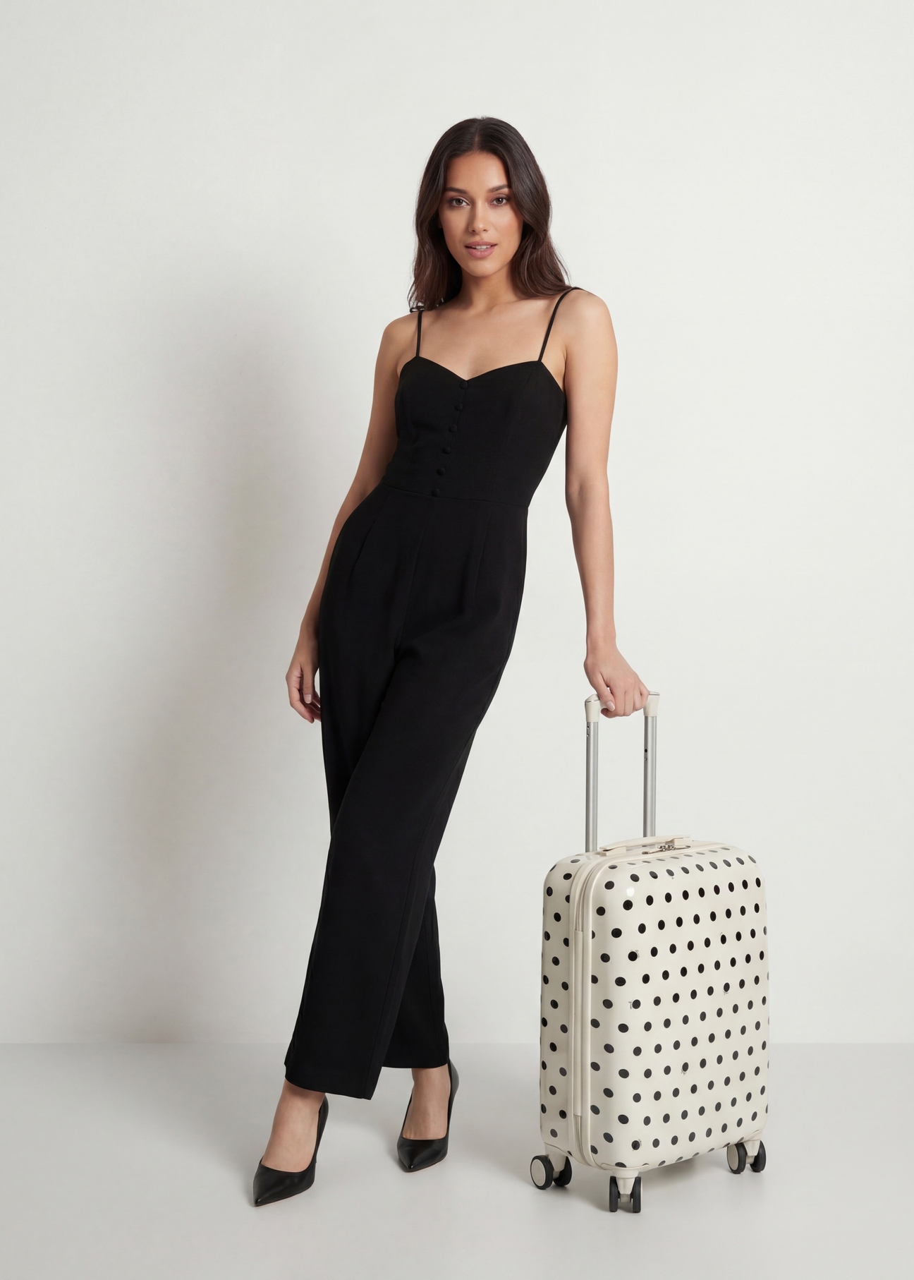 Small polka dot suitcase on wheels WALAB-0074-0P-19(W26), diagonal view of the product next to the model's silhouette.